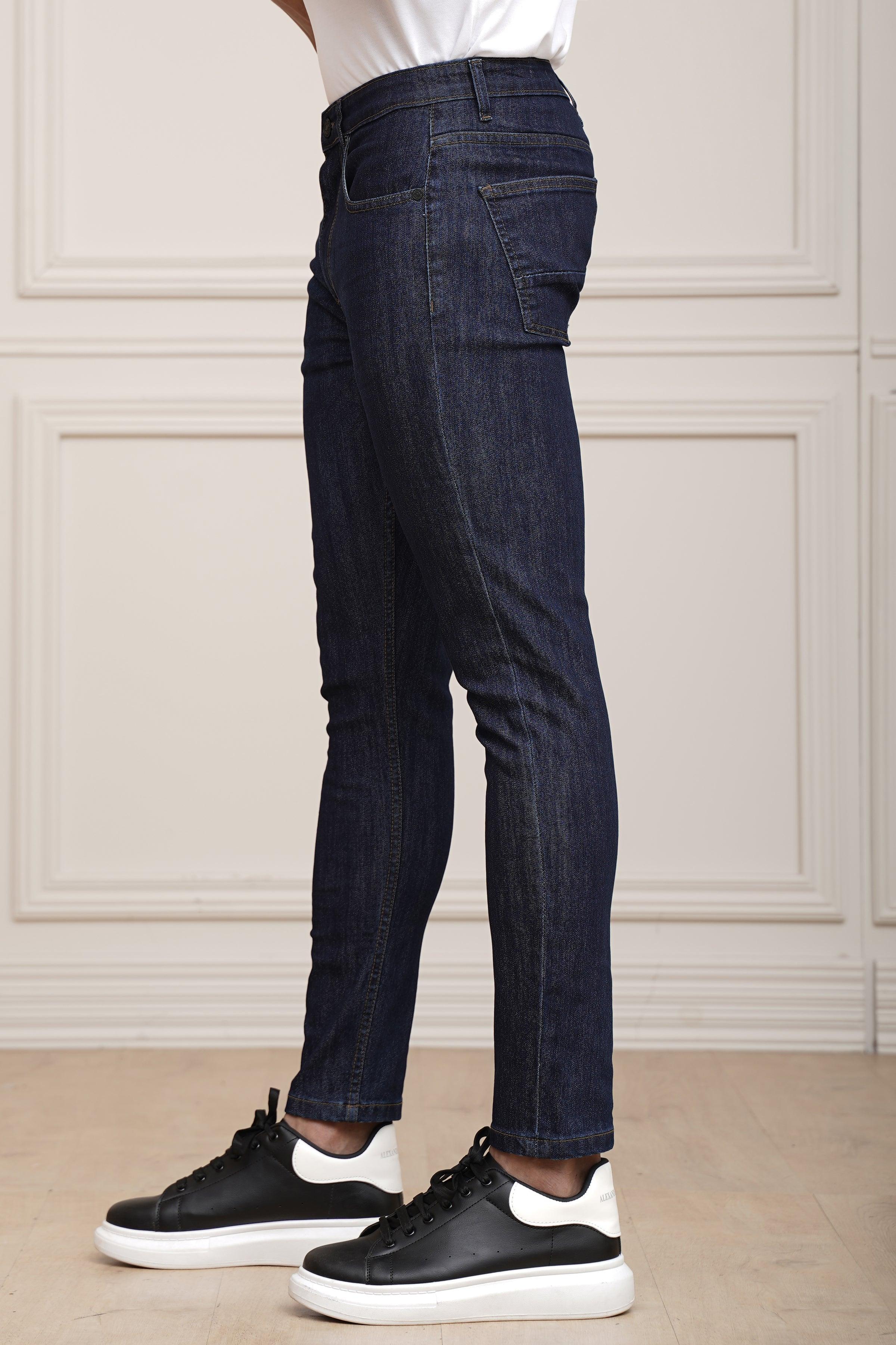 Navy blue slim-fit jeans with five pockets, belt loops, and button fly