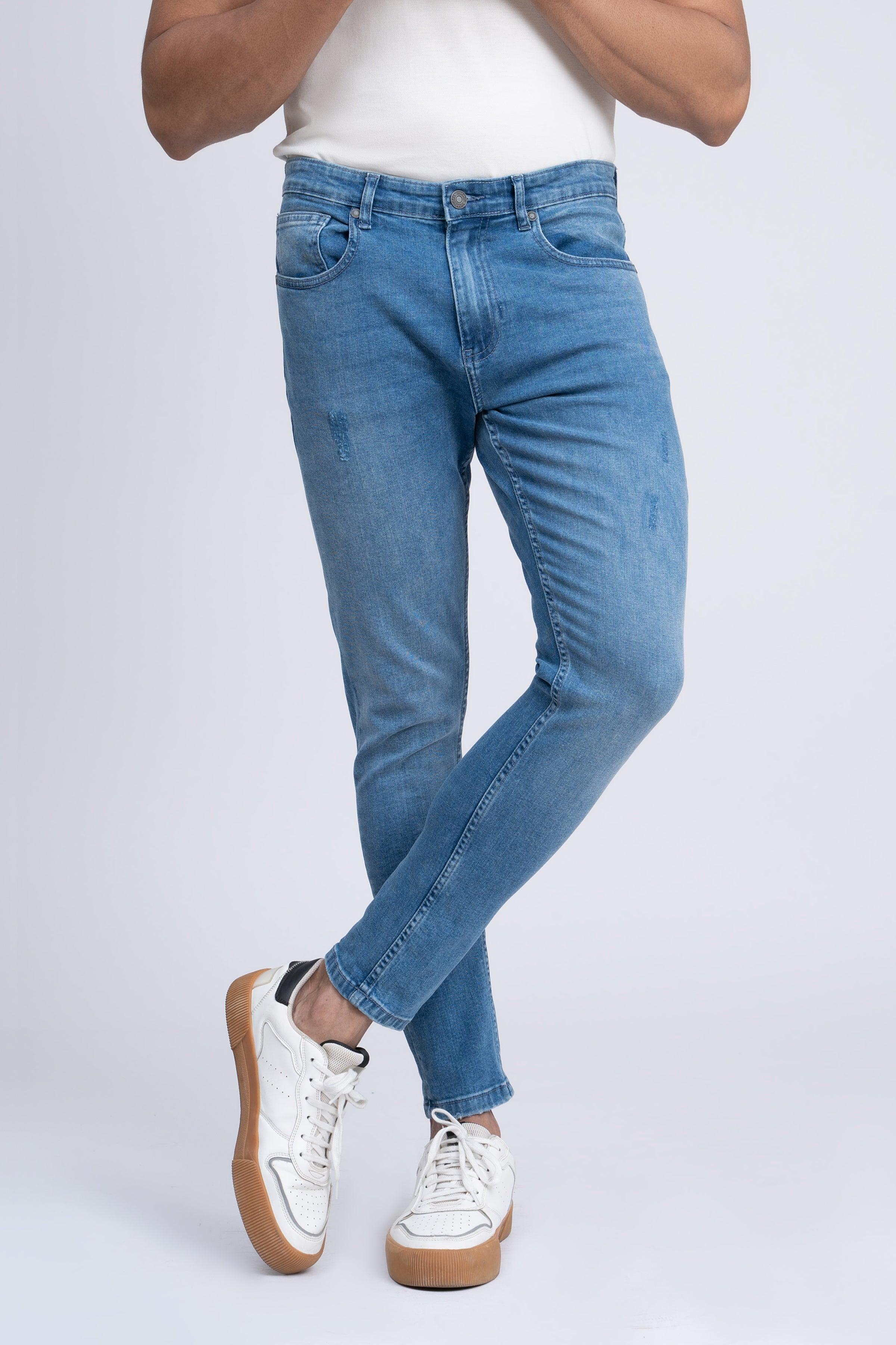 Light blue skinny jeans with slim fit, button closure, and zip fly