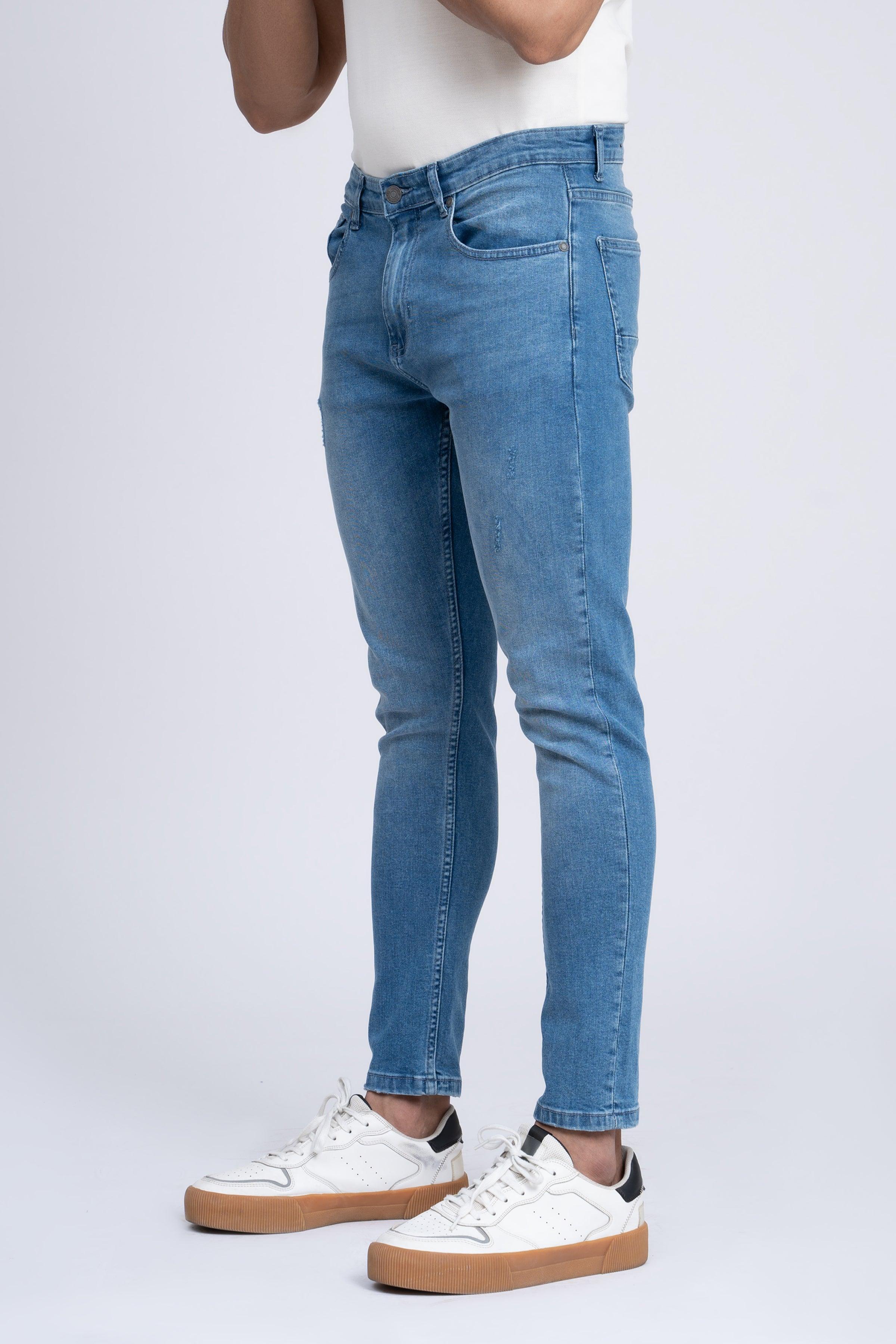 Light blue skinny jeans with slim straight leg, belt loops, and zip fly