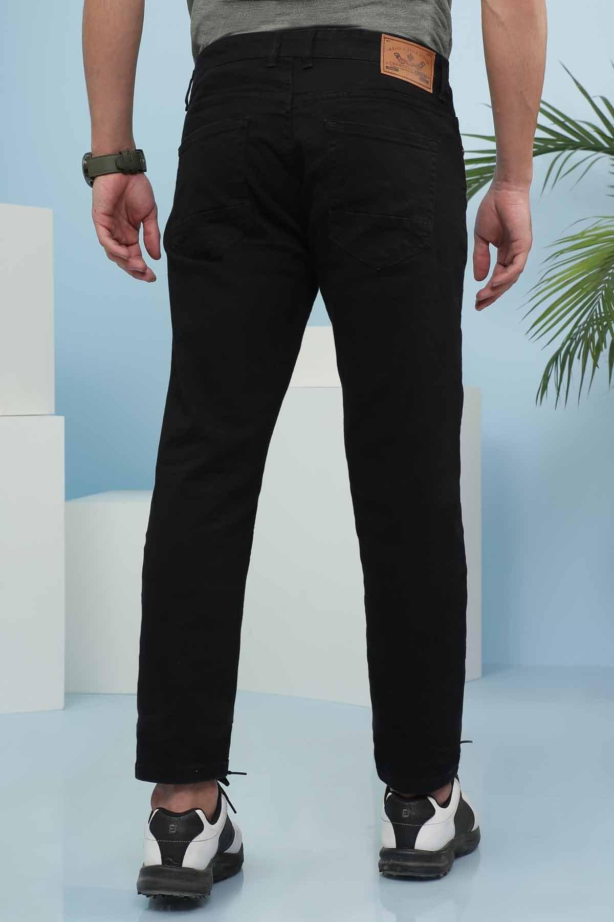 Slim-fit black jeans, rear view with waistband tag and back pockets