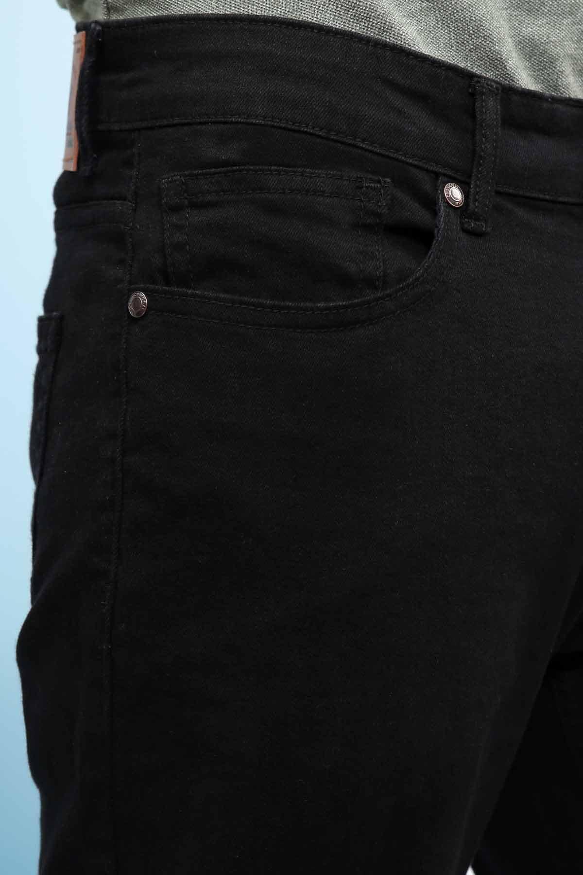 Black jeans close-up: coin pocket, seam detail and metal button