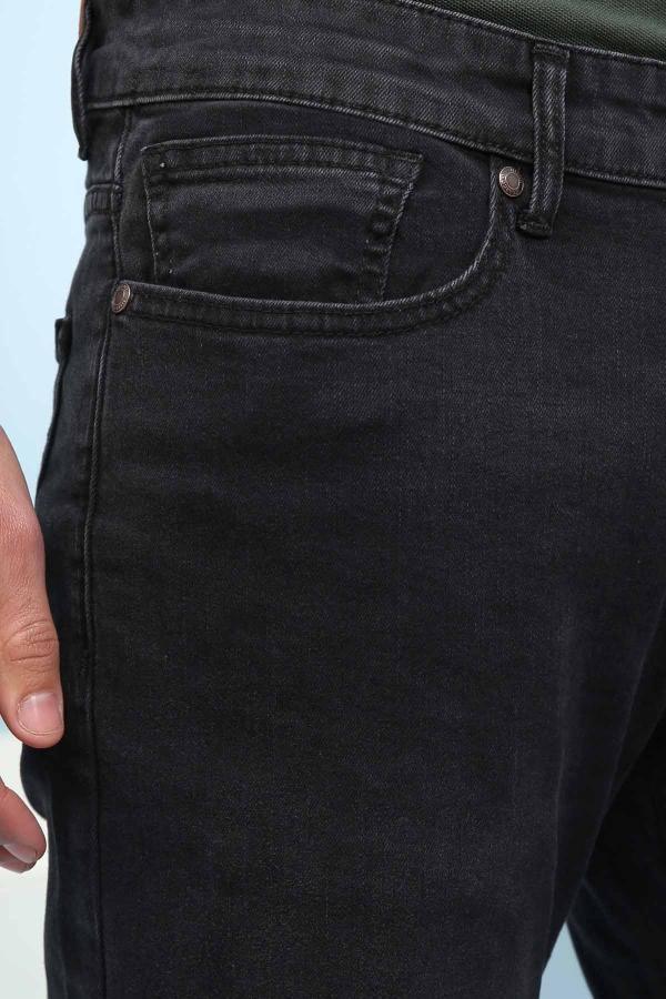 Dark jeans front pocket and coin pocket detail with metal rivets