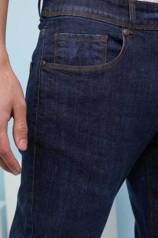 Dark blue denim jeans close-up of front pocket and stitched waistband