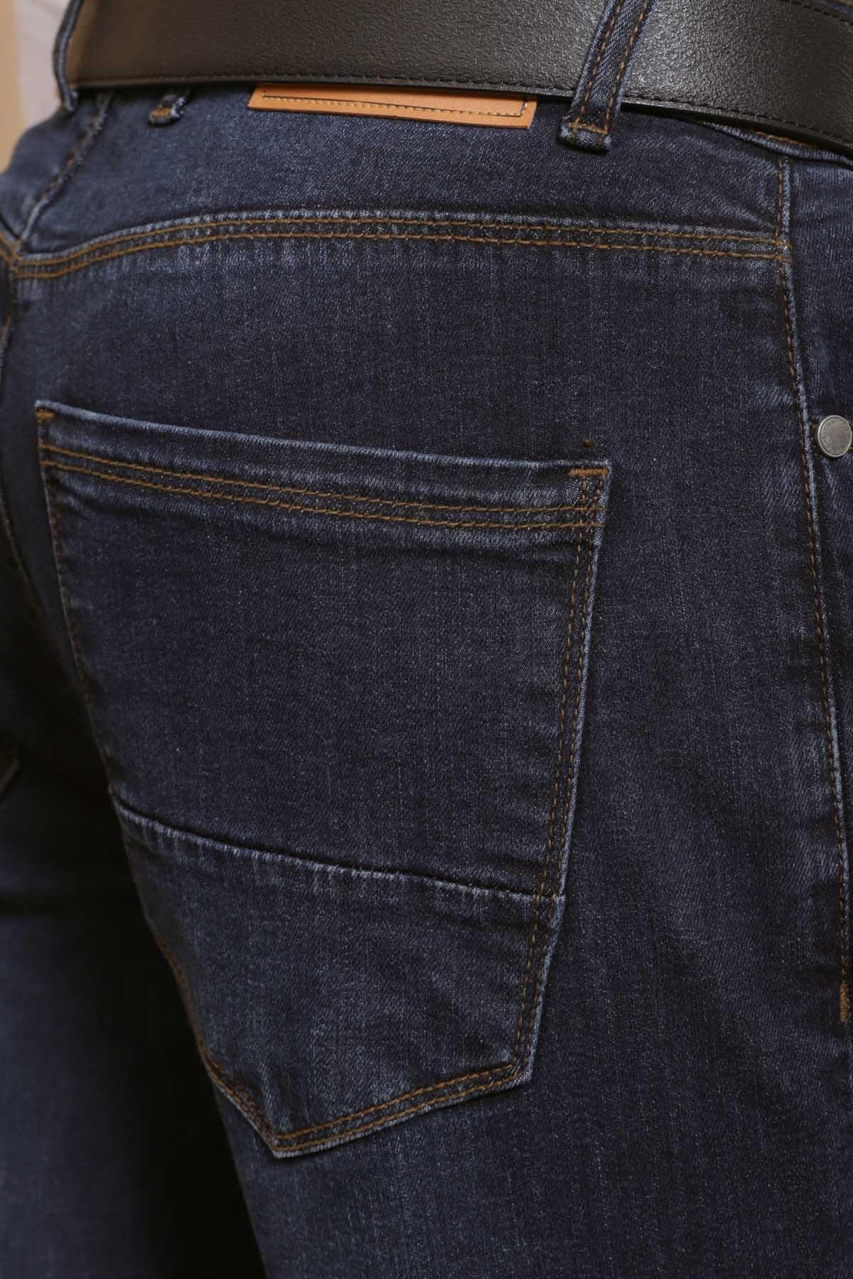 Slim-fit jeans close-up, dark denim front pocket and stitch details