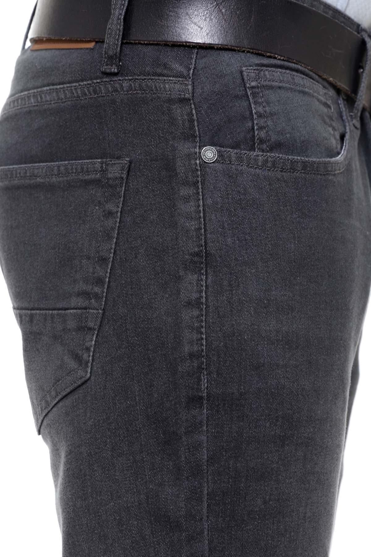 Slim-fit dark grey jeans close-up, rear pocket and denim seam details