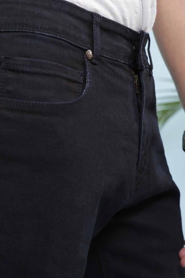 Slim-fit navy jeans close-up of front pocket, stitching, and belt loop