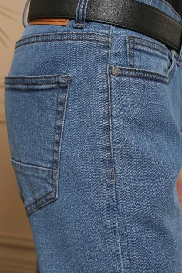 Light blue denim jeans close-up of front pockets and button