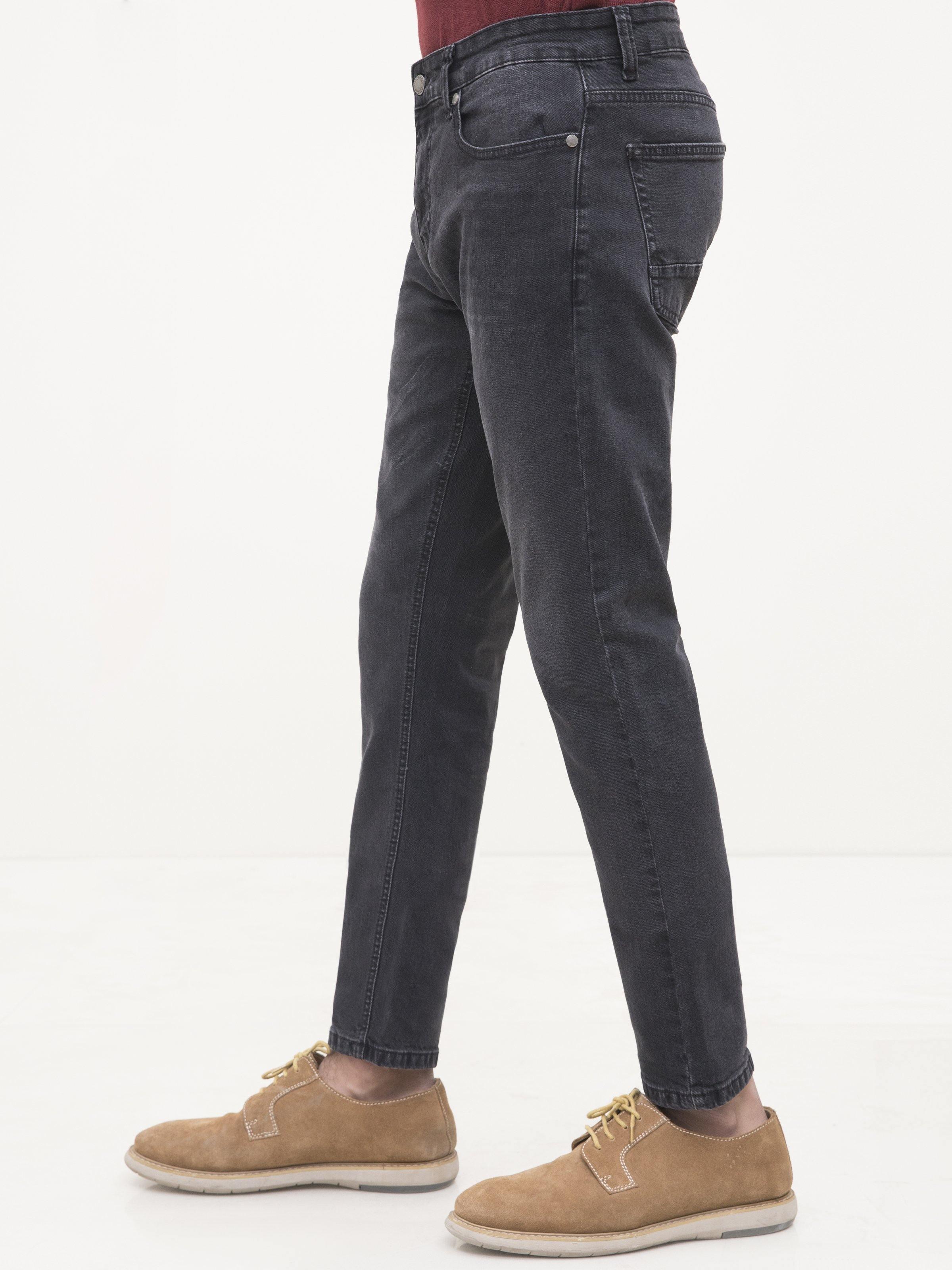 Dark grey slim-fit jeans with five-pocket design and belt loops, side view.