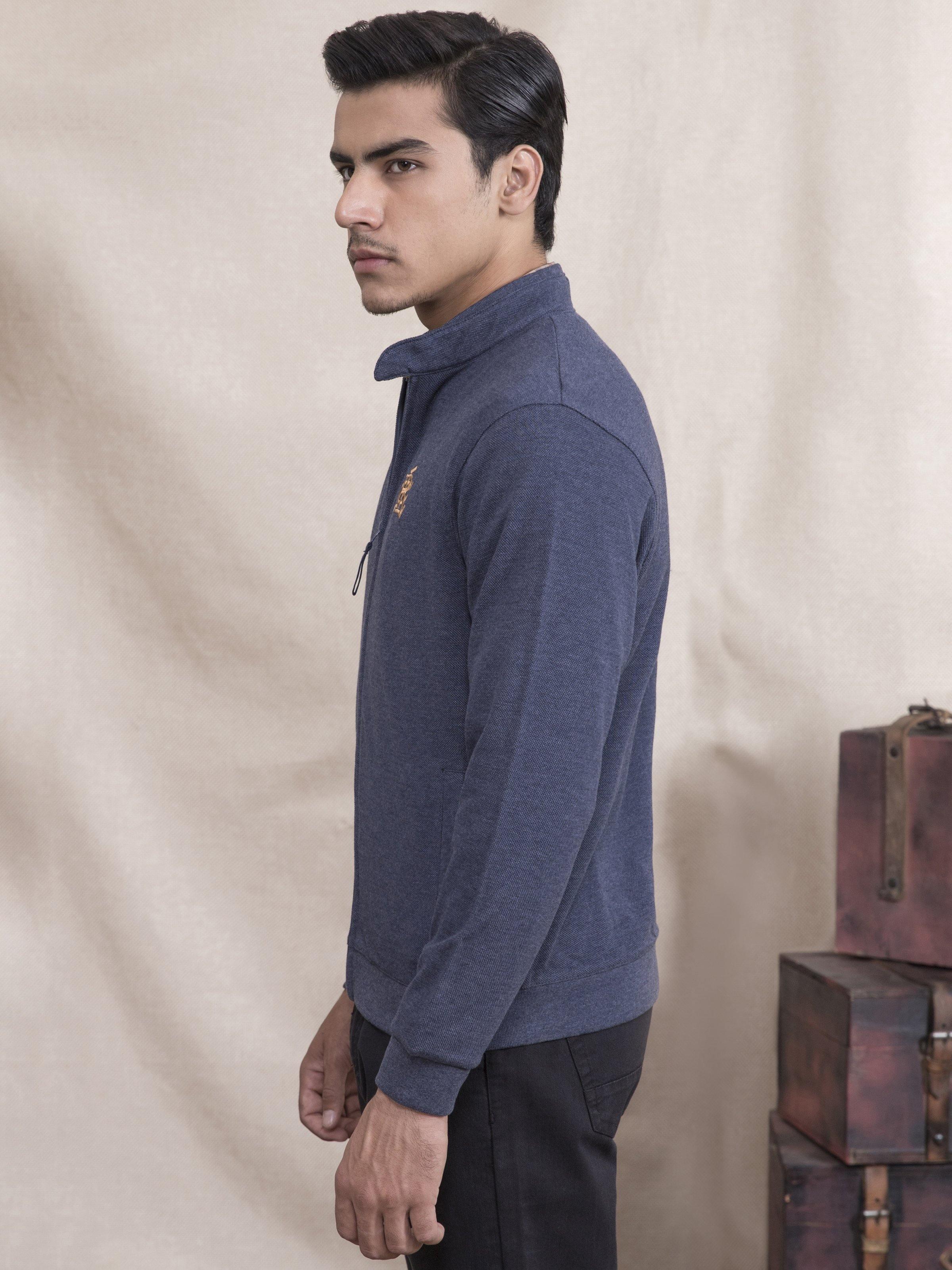 Navy blue zip-up knit jacket, side view with stand collar and long sleeves