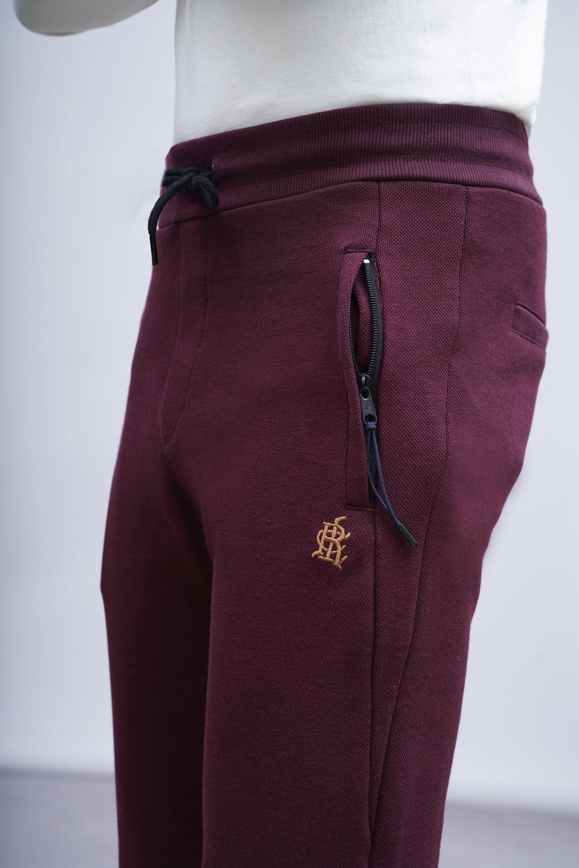 Maroon pique trousers with zip fly detail and small logo at thigh