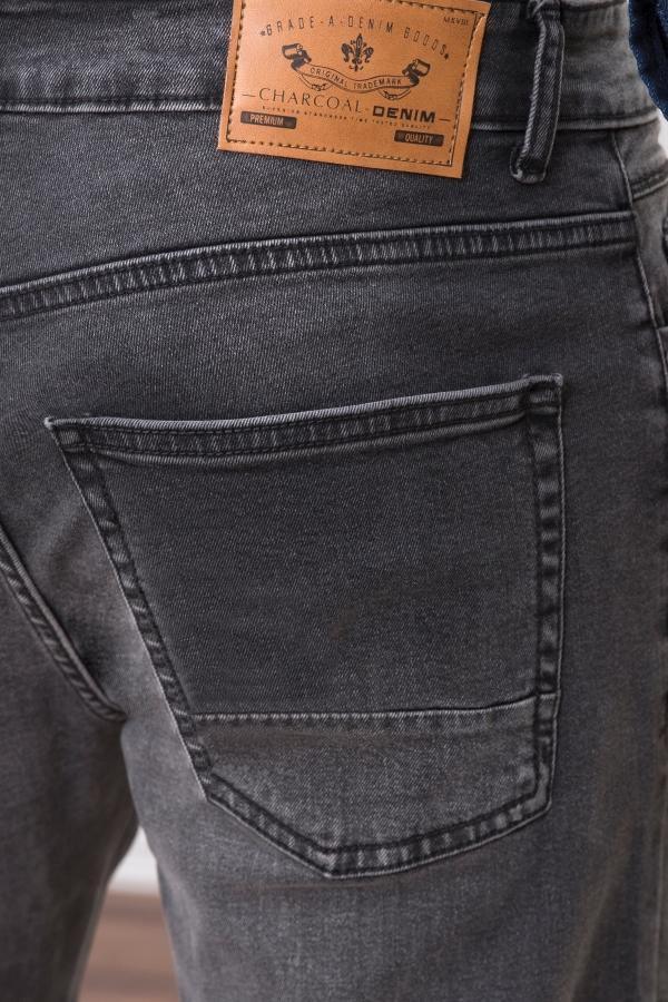 Dark grey slim-fit jeans with leather brand patch and front coin pocket close-up