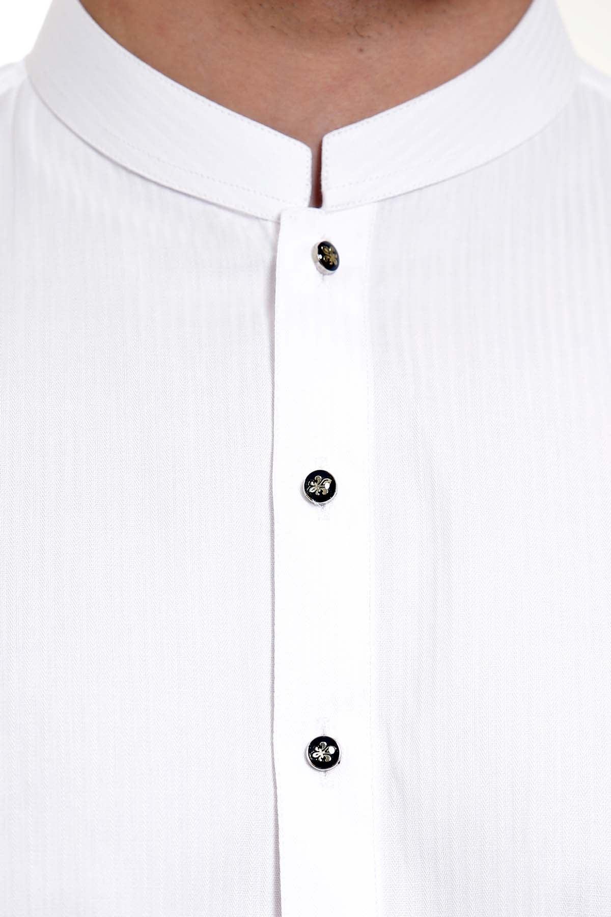 Band collar close-up with three dark buttons on white tunic placket