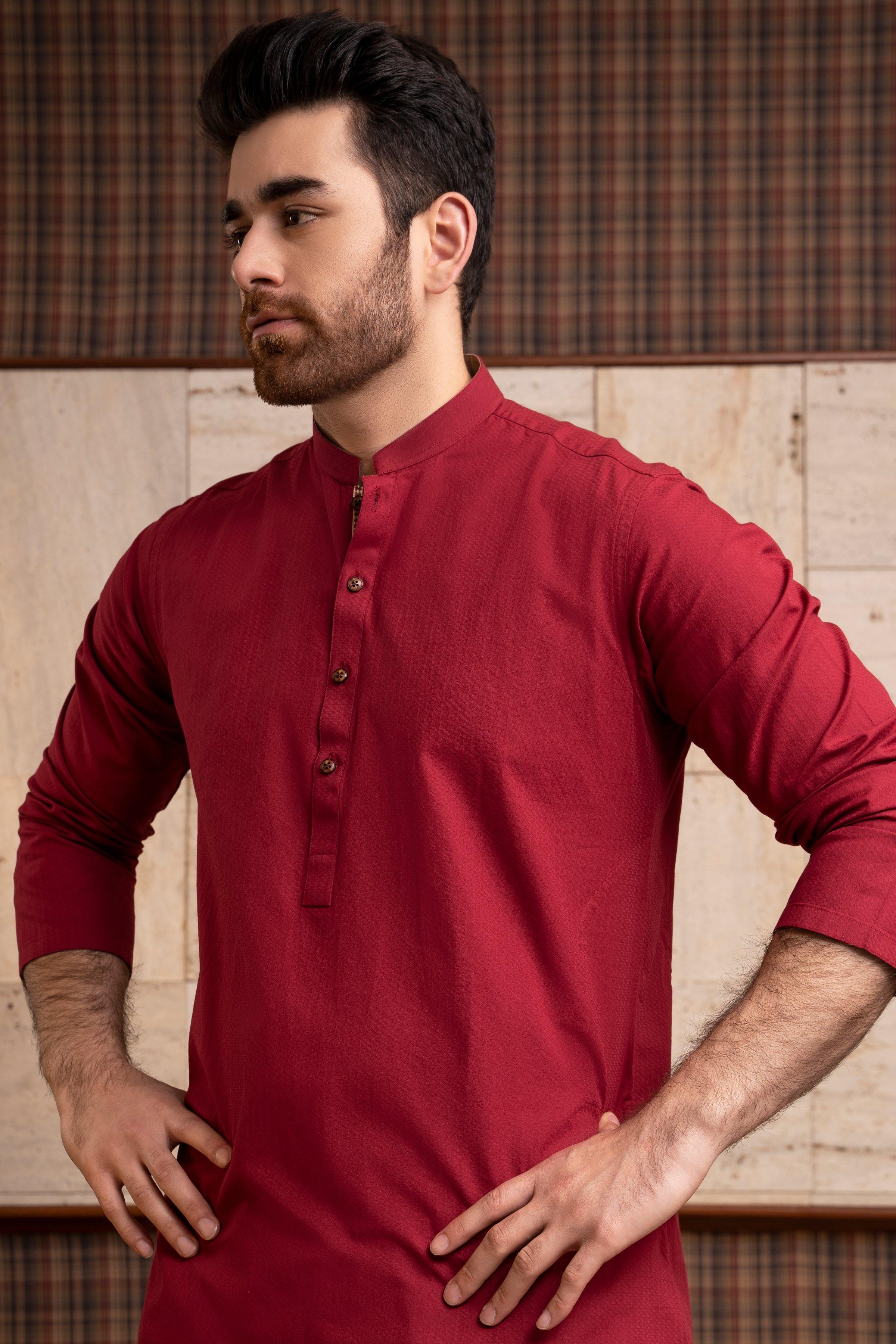 Maroon kurta with band collar and button placket, long sleeves, hands-on hips