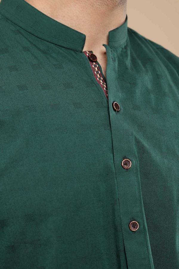 Green band-collar kurta close-up with brown buttons and textured fabric