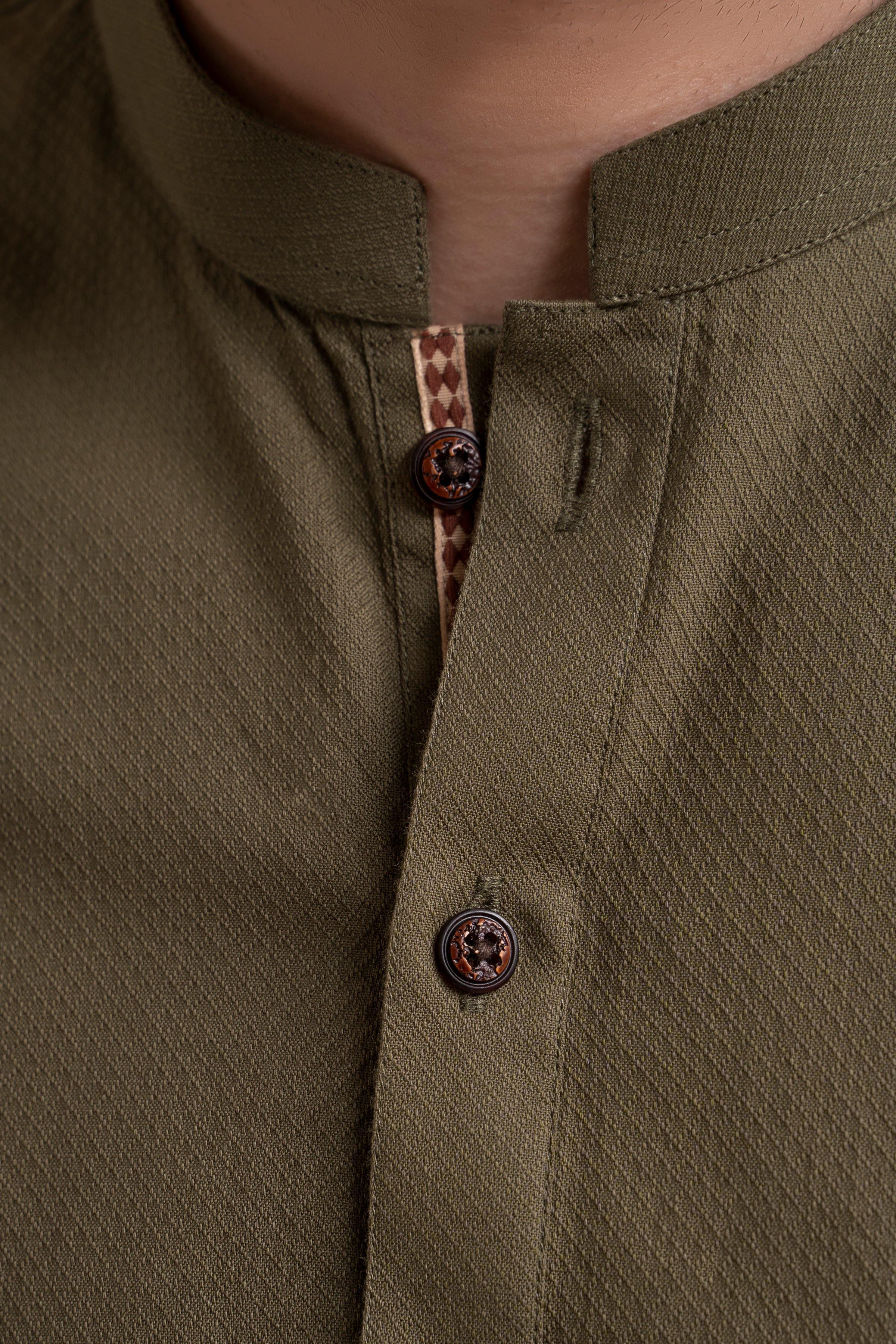 Green kurta placket with patterned buttons and band collar, close-up