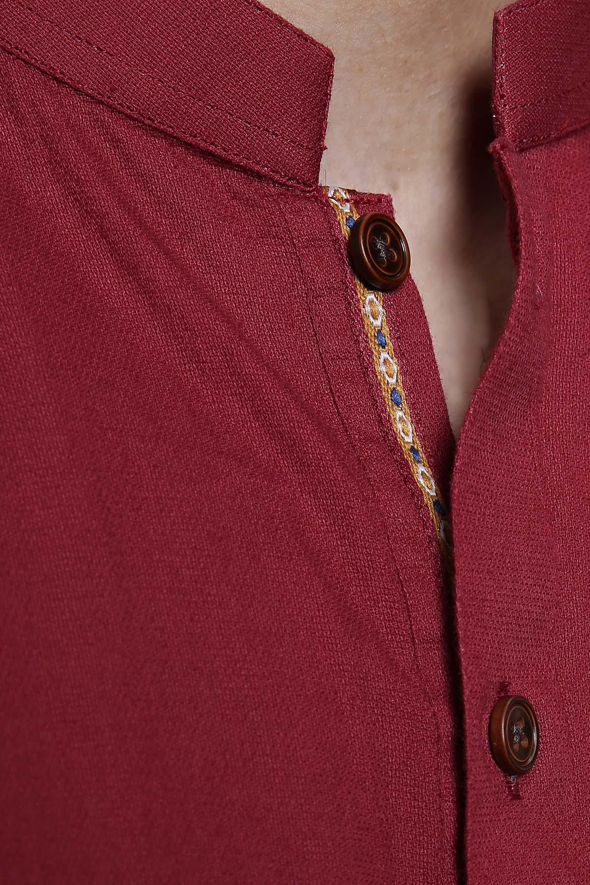 Maroon kurta fabric close-up with decorative trim and button front