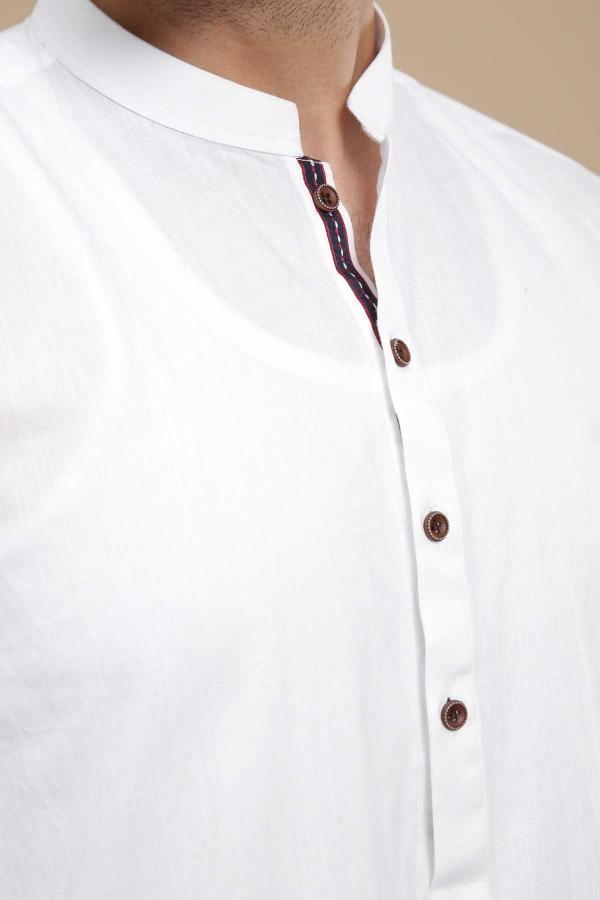 White kurta collar with band neckline and brown buttons, close-up