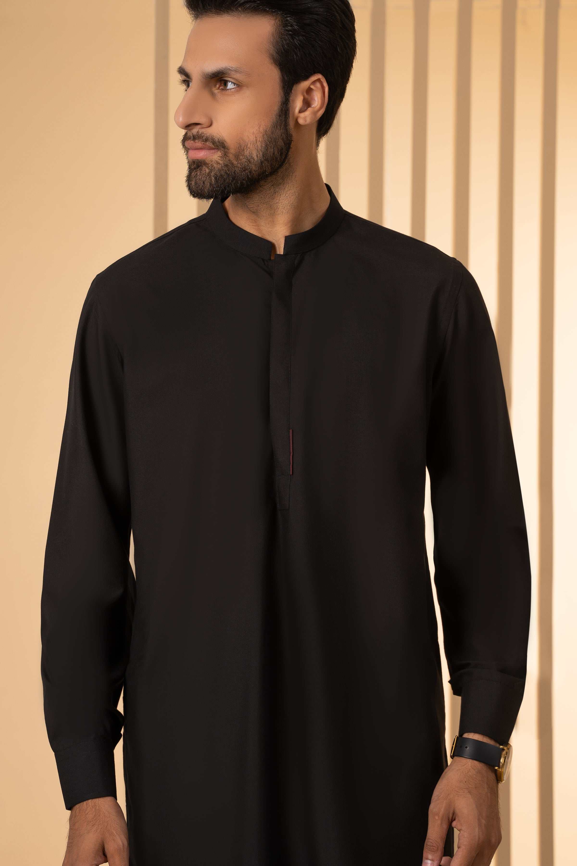 Men's black kurta close-up with stand collar and central button placket
