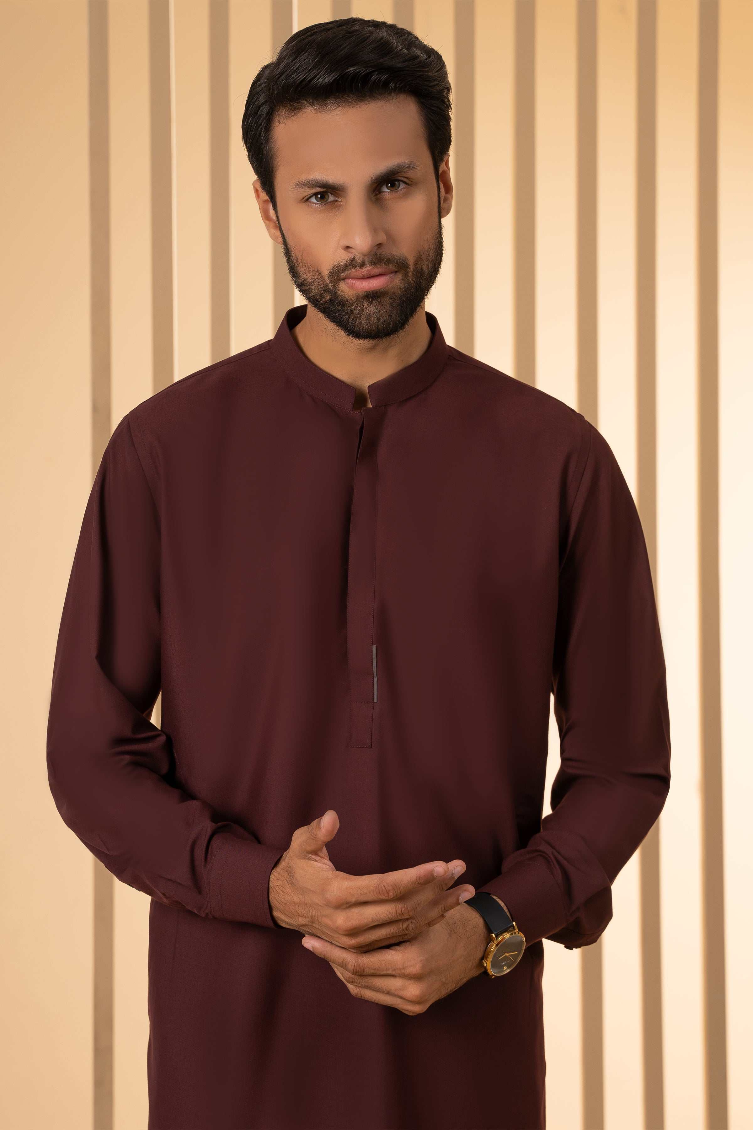 Maroon kurta with stand collar and button placket, worn with matching trousers