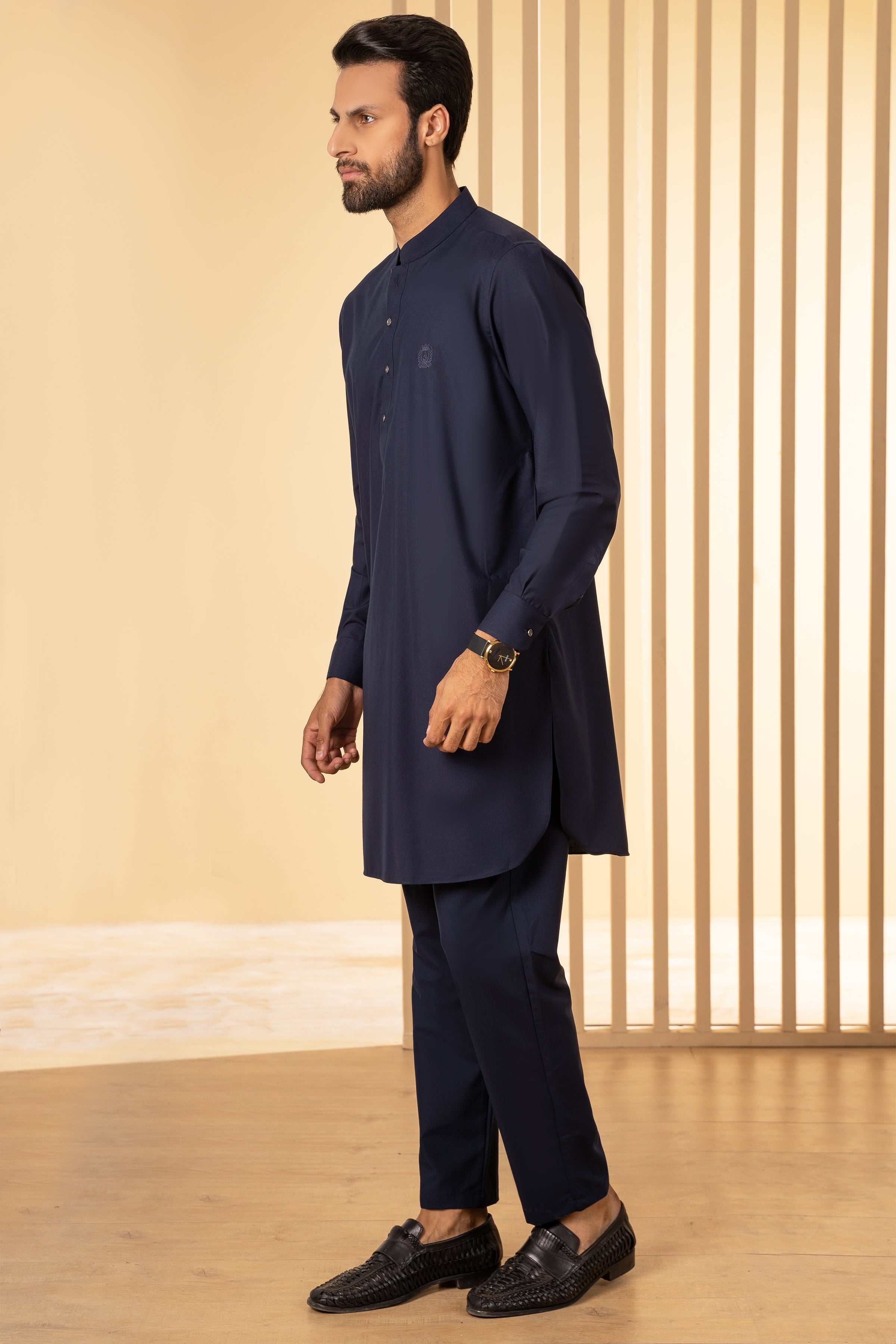 Navy kurta pajama set, side profile: long tunic with buttons and tapered pajama pants