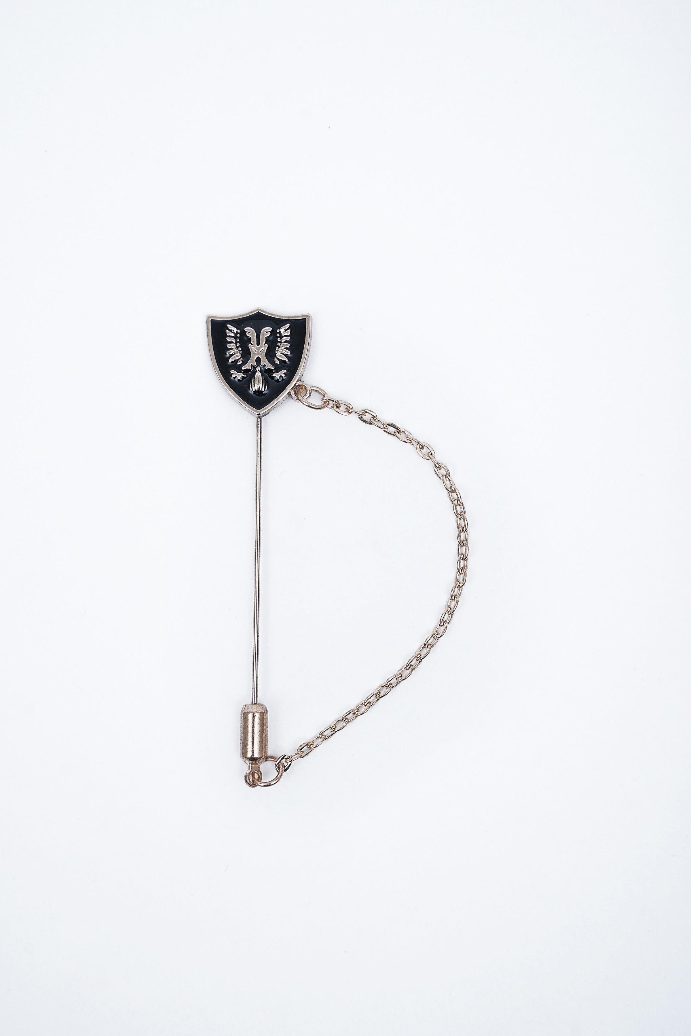 Shield enamel lapel pin with black face, silver emblem, pin stem and chain loop
