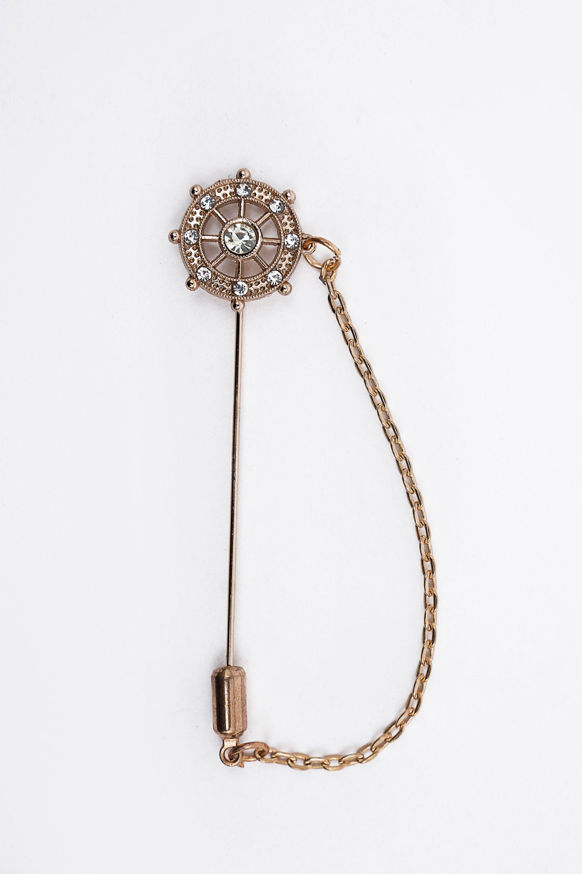 Round rhinestone lapel pin with clock face and gold tone safety pin and chain