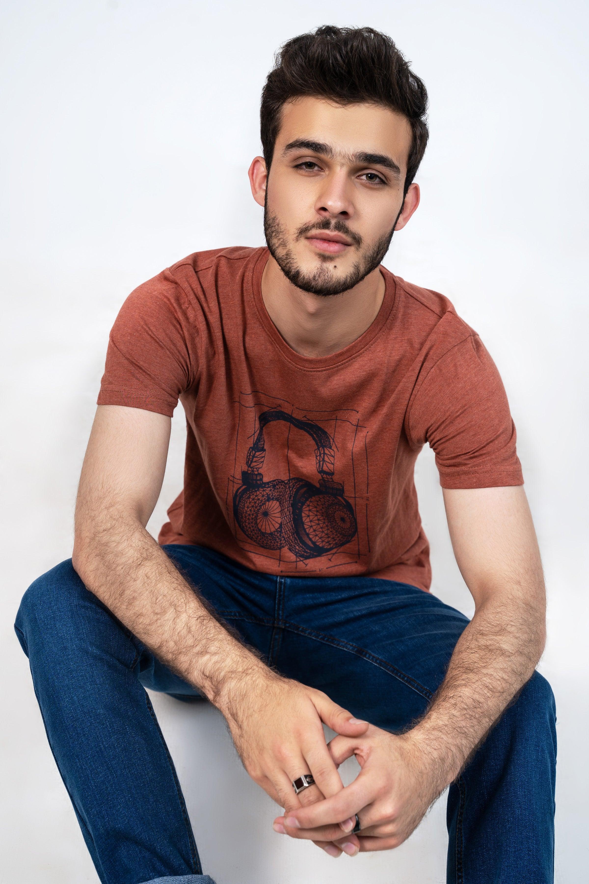 Rust crewneck T-shirt with headphone music graphic, close-up front view
