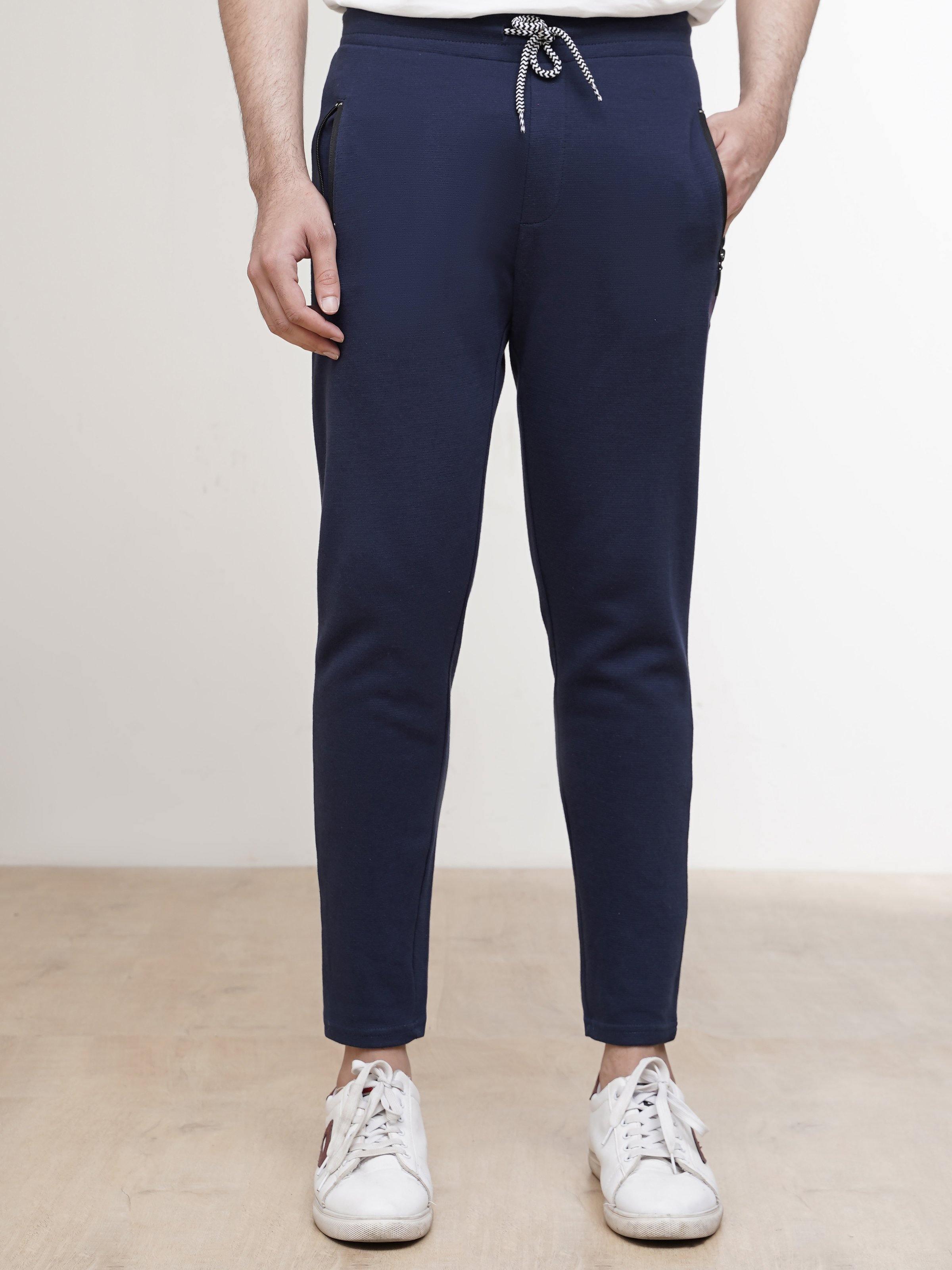 Dark blue jogger trousers with drawstring waist and tapered ankle cuffs
