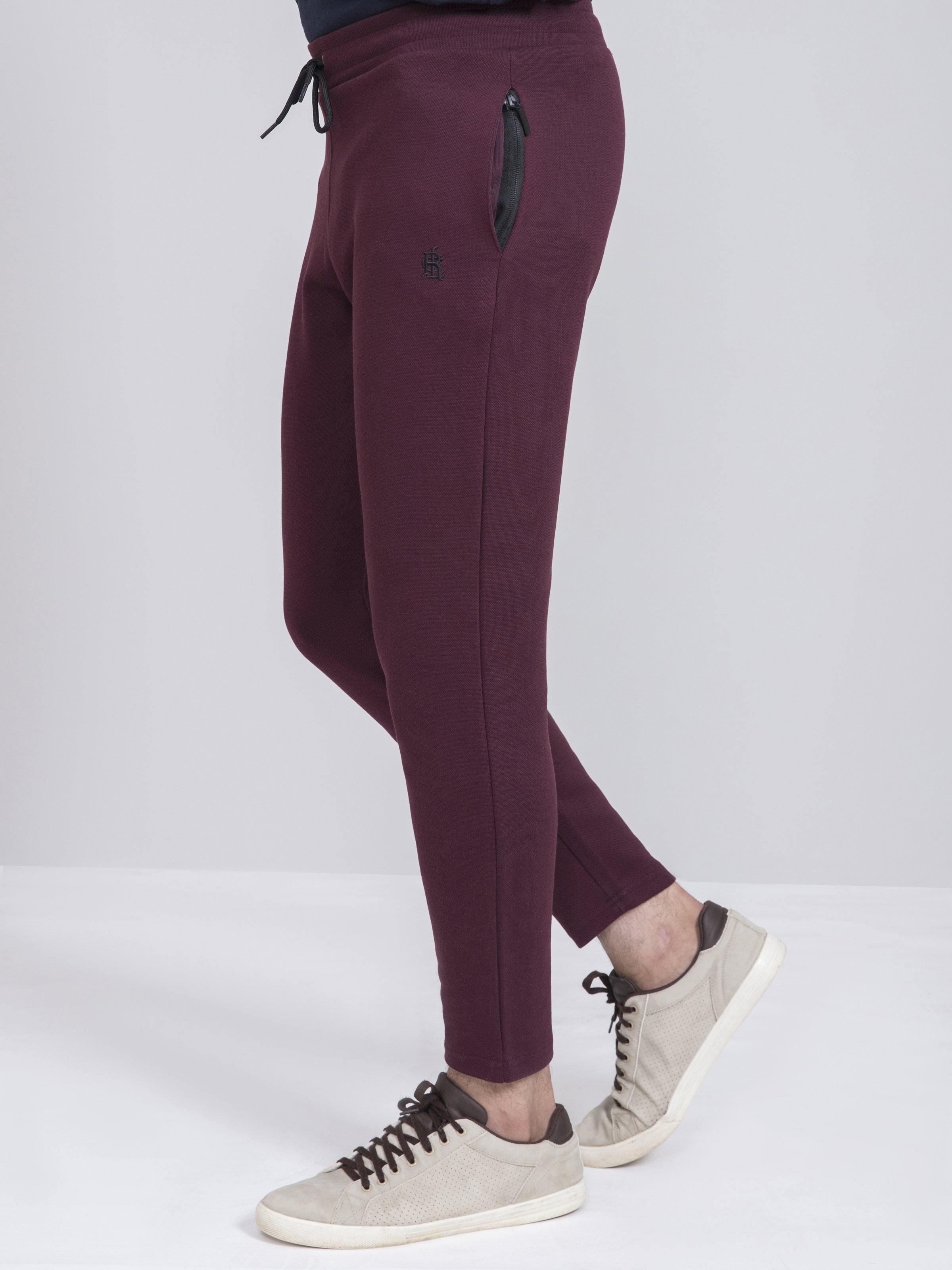 Maroon slim-fit trousers with drawstring waist and side zip pocket