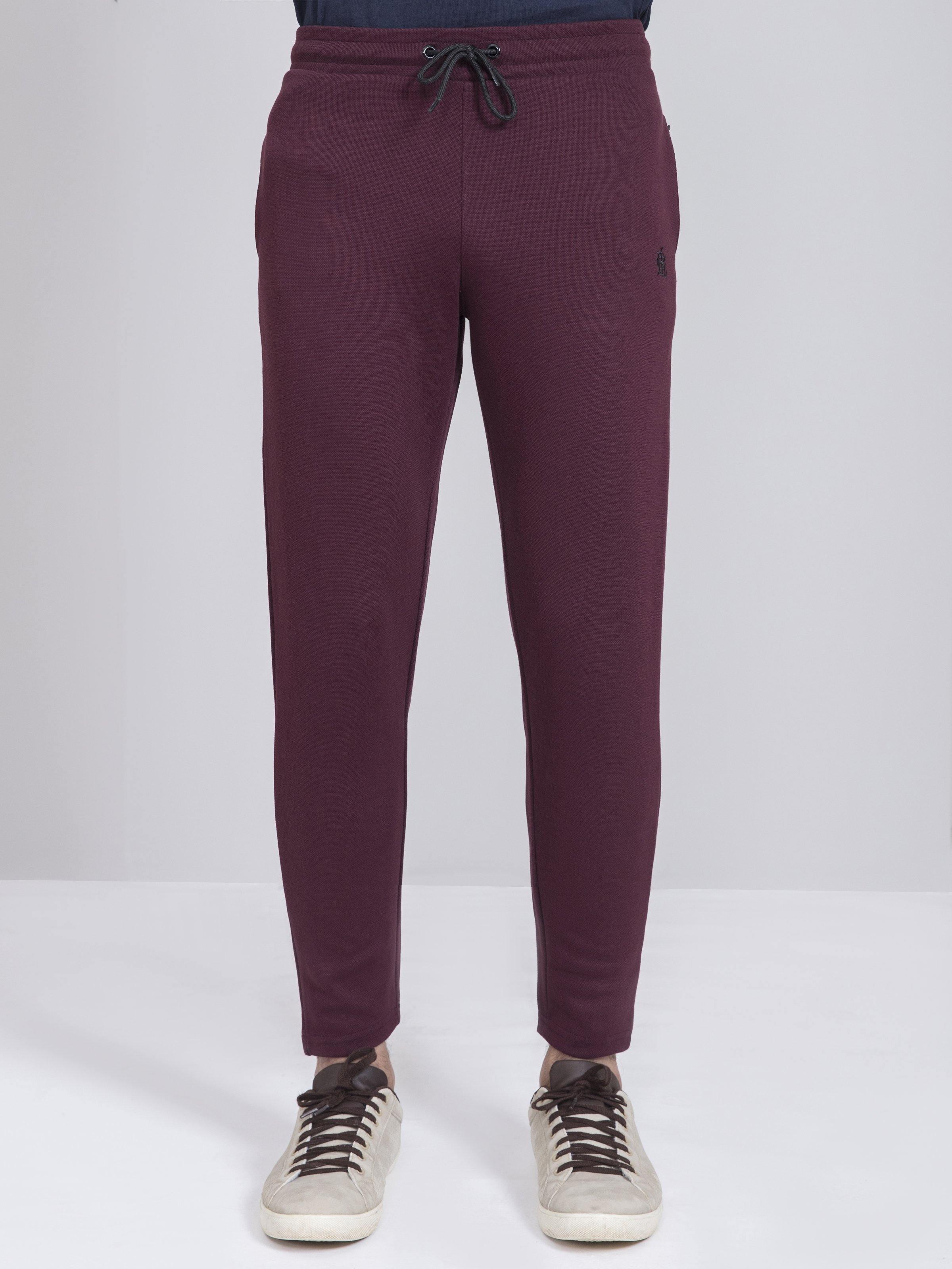 Maroon slim-fit trousers with drawstring waist and tapered ankle-length legs