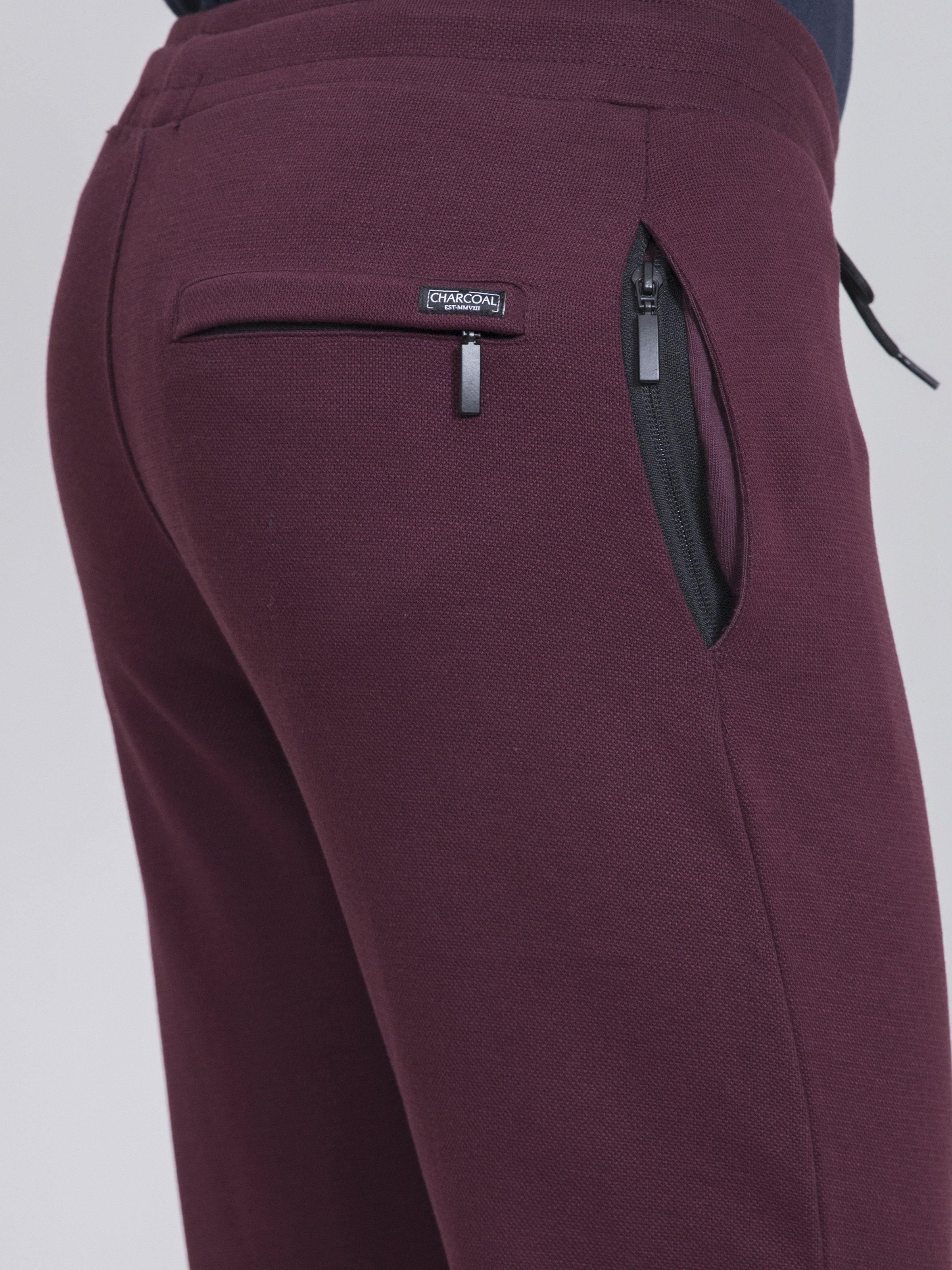 Maroon trousers with back zip pocket and small logo patch
