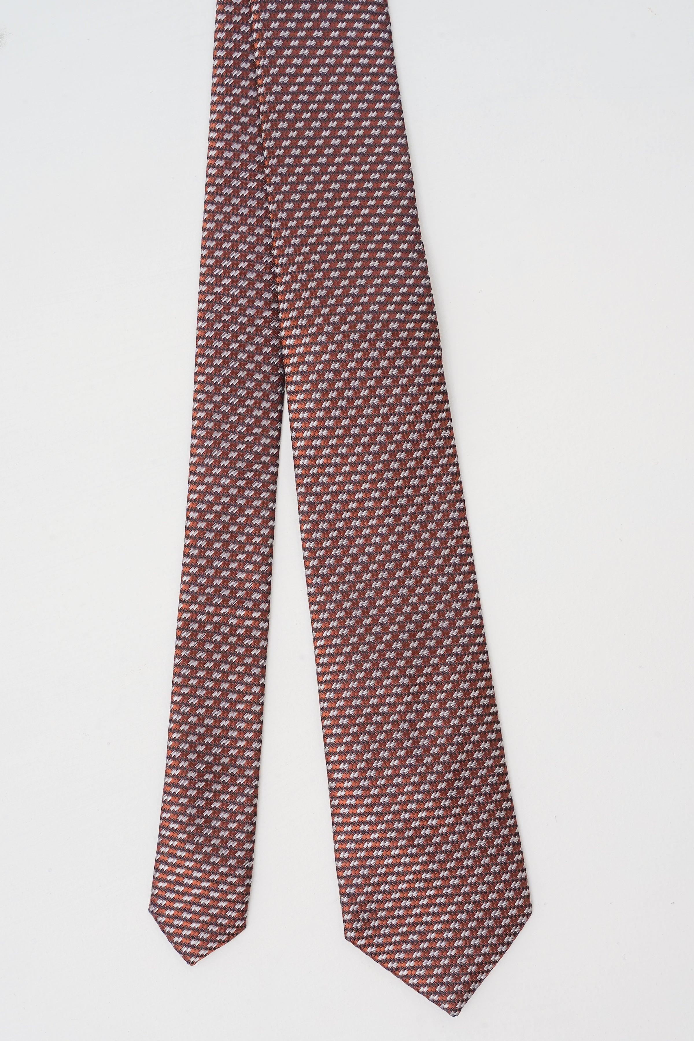 Maroon geometric silk tie, long pointed ends with slim width and repeating micro pattern.