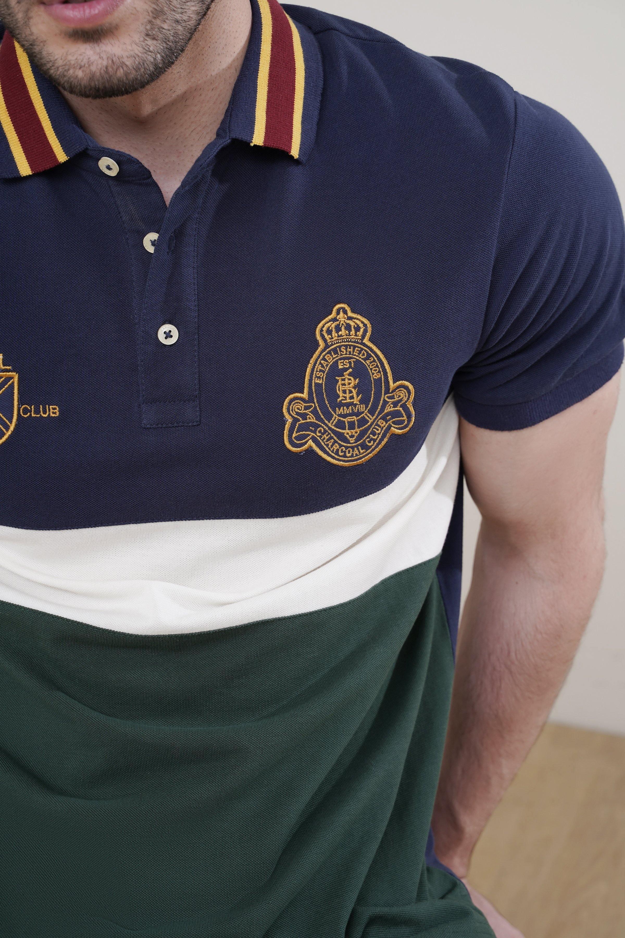 Navy polo shirt collar with striped trim and crest logo; button placket