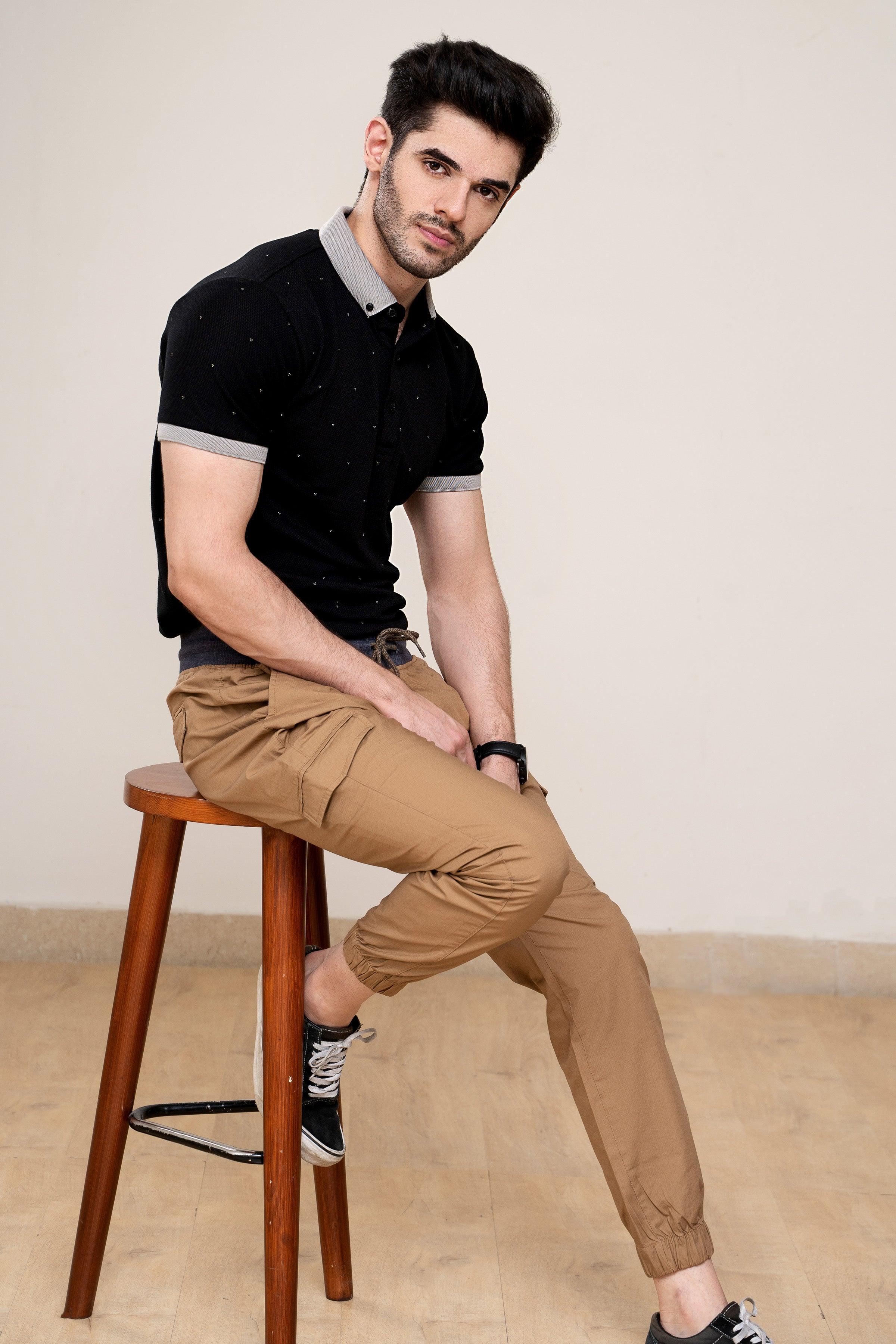 Black polo shirt with white contrast collar and button placket, short sleeves