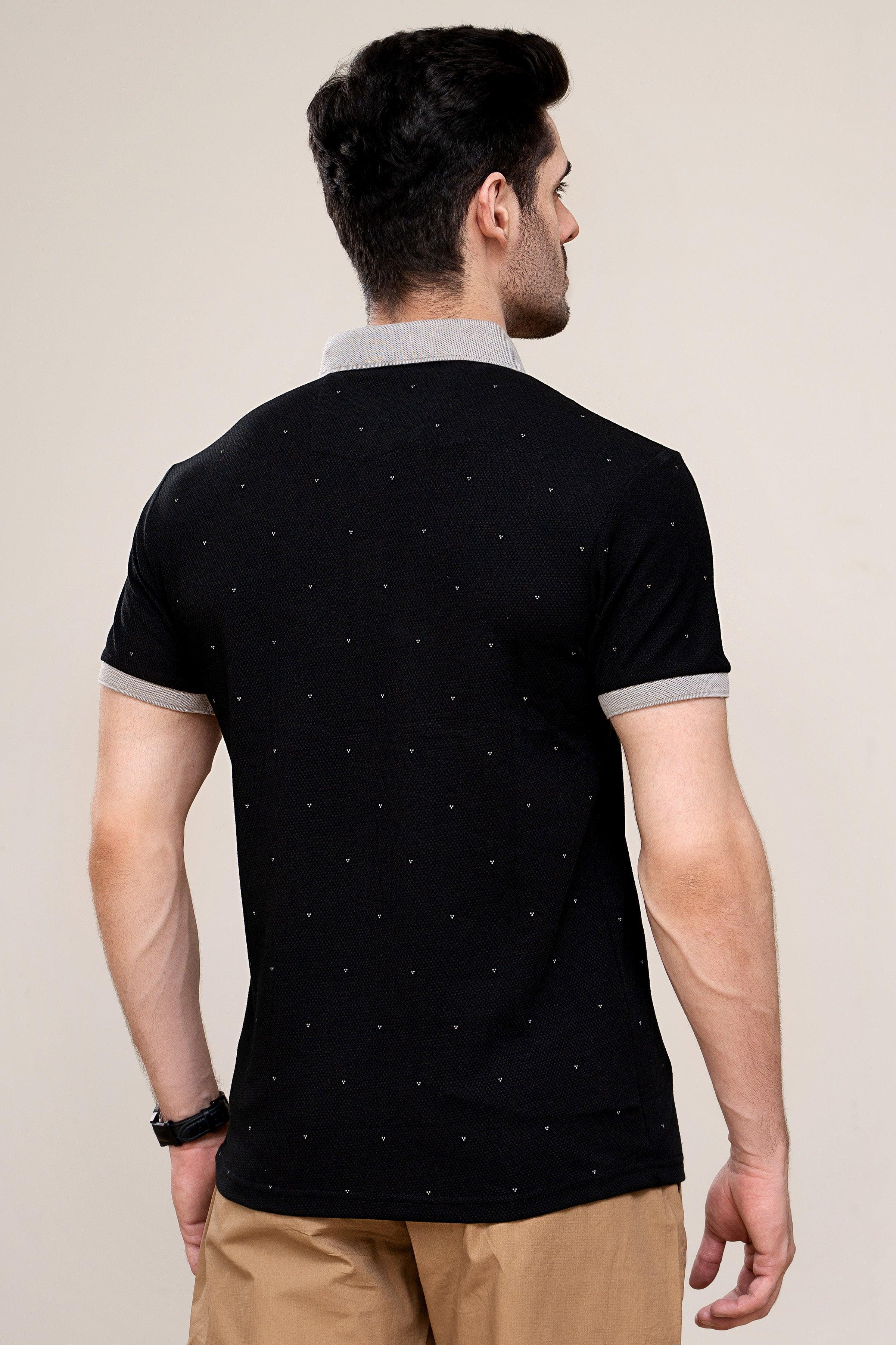 Back view of black polo shirt with white collar trim and short sleeves