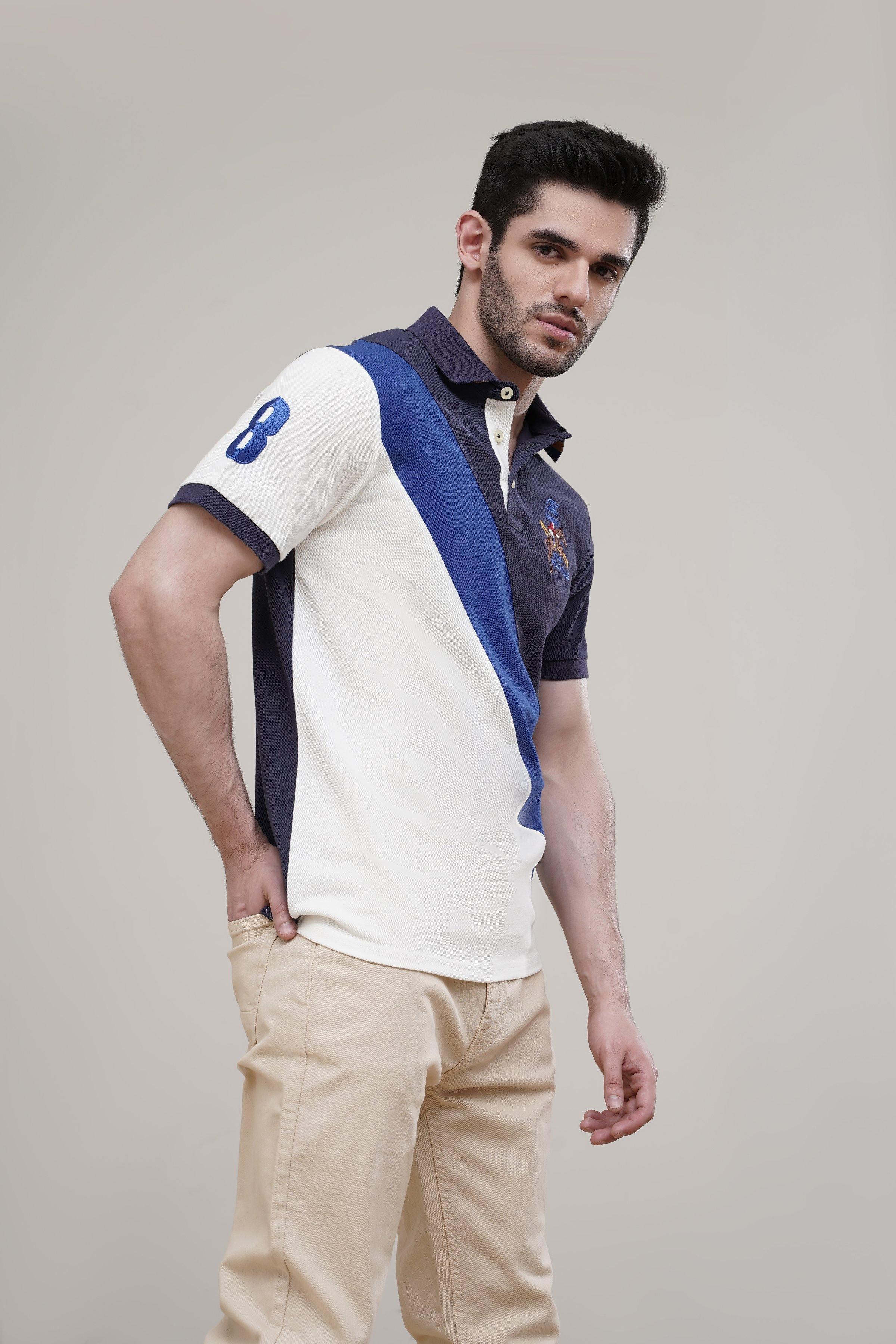 Navy polo shirt with diagonal white cross panel on front and sleeve