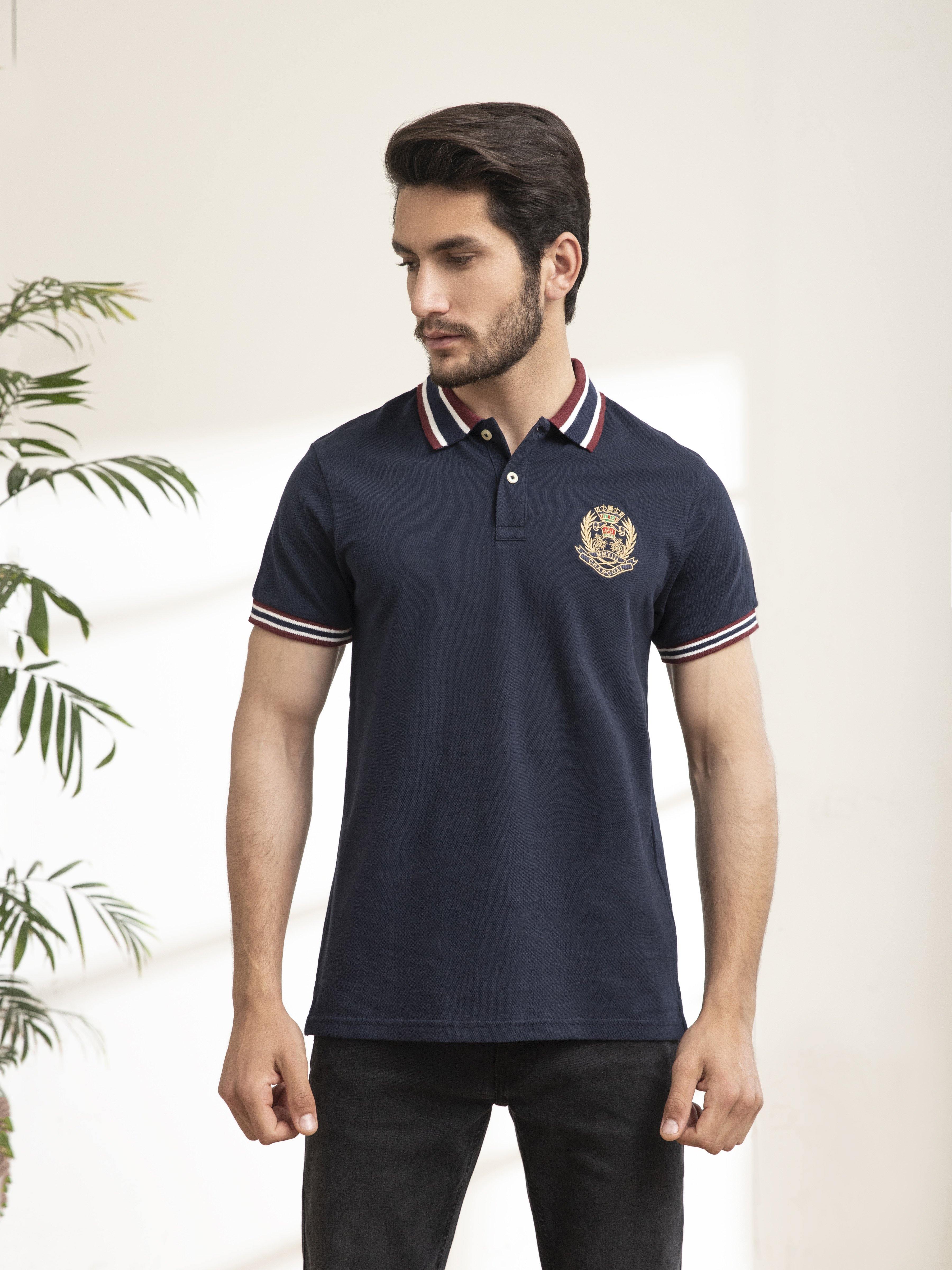 Navy polo shirt with striped collar and sleeves, short button placket, chest emblem