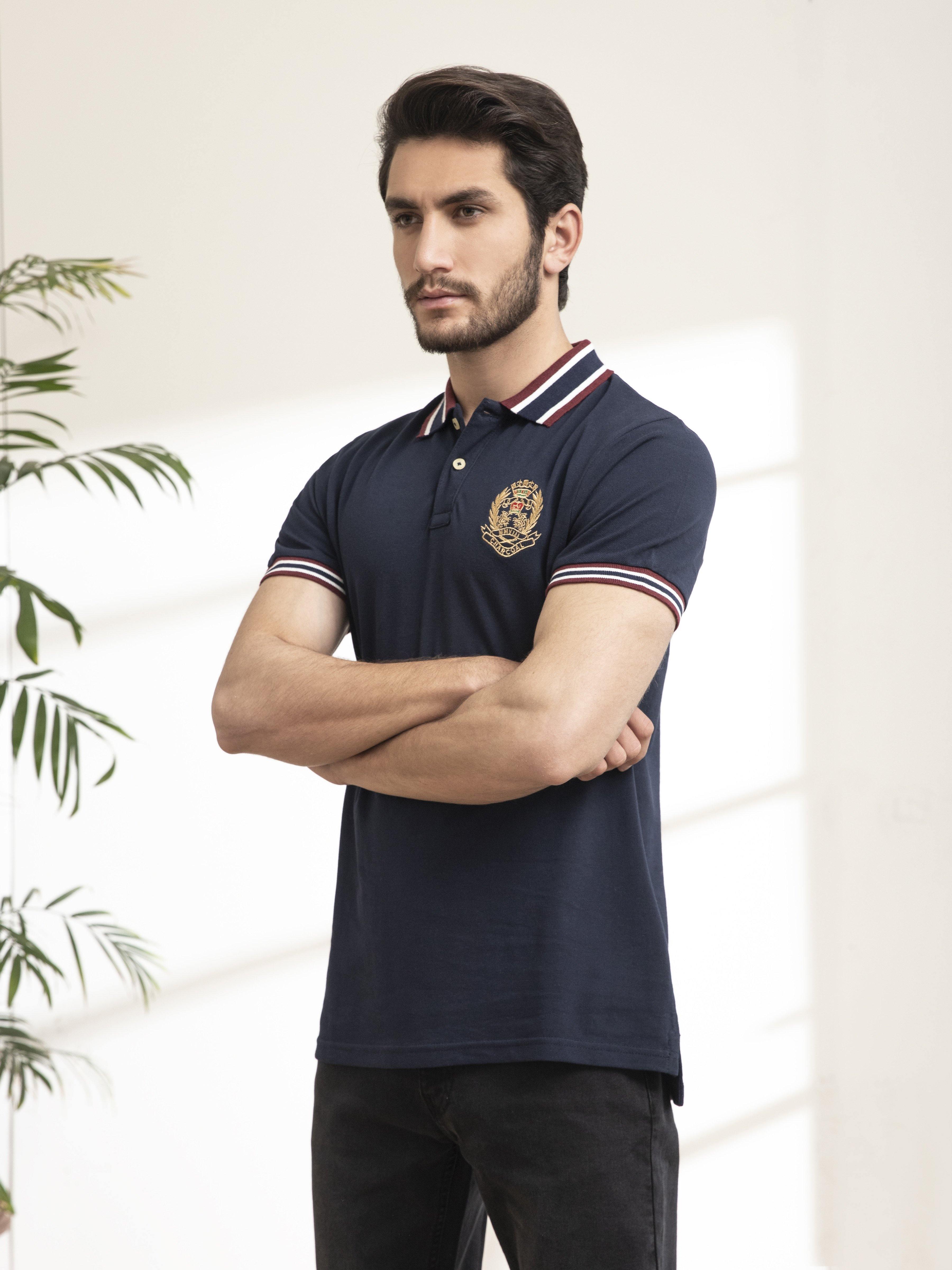 Navy polo shirt with jacquard collar, button placket, striped cuffs and chest crest