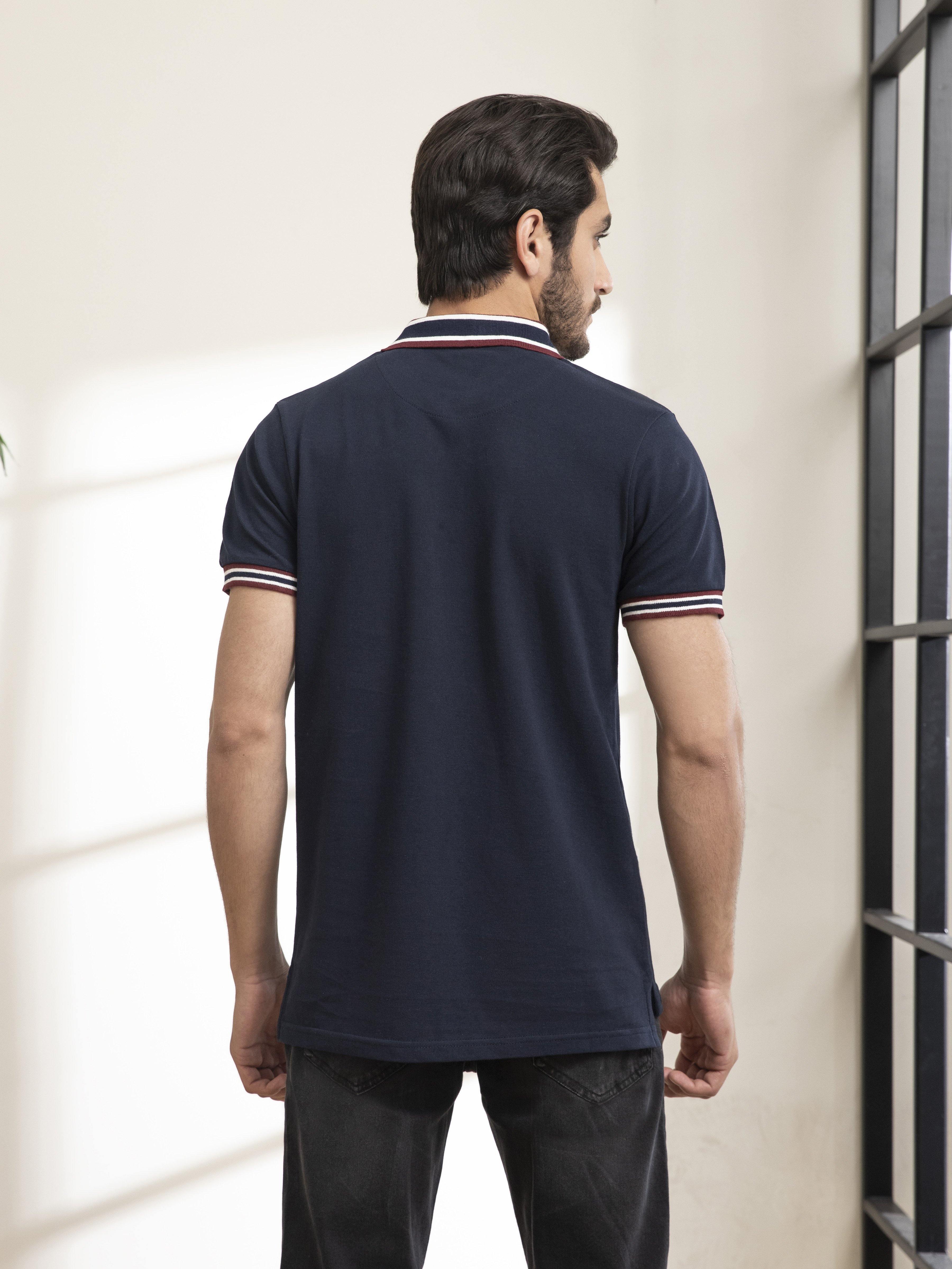 Navy polo shirt back view with striped collar and sleeve cuffs
