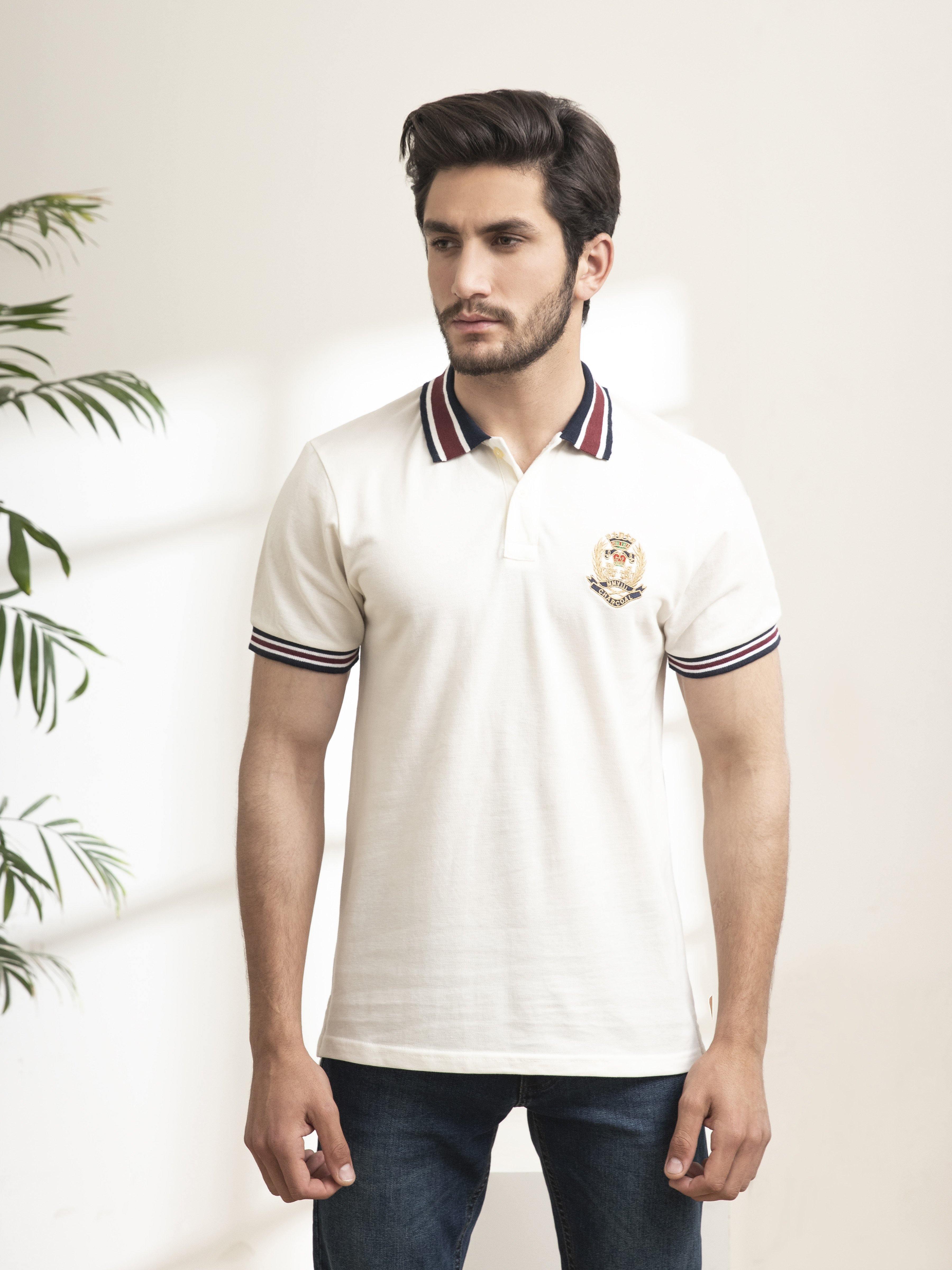 Off-white polo shirt, striped trim on collar and sleeves, chest crest logo