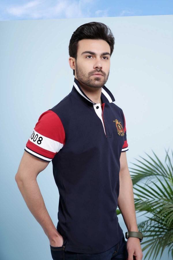 Navy polo shirt with crest logo and red striped sleeve with number 008