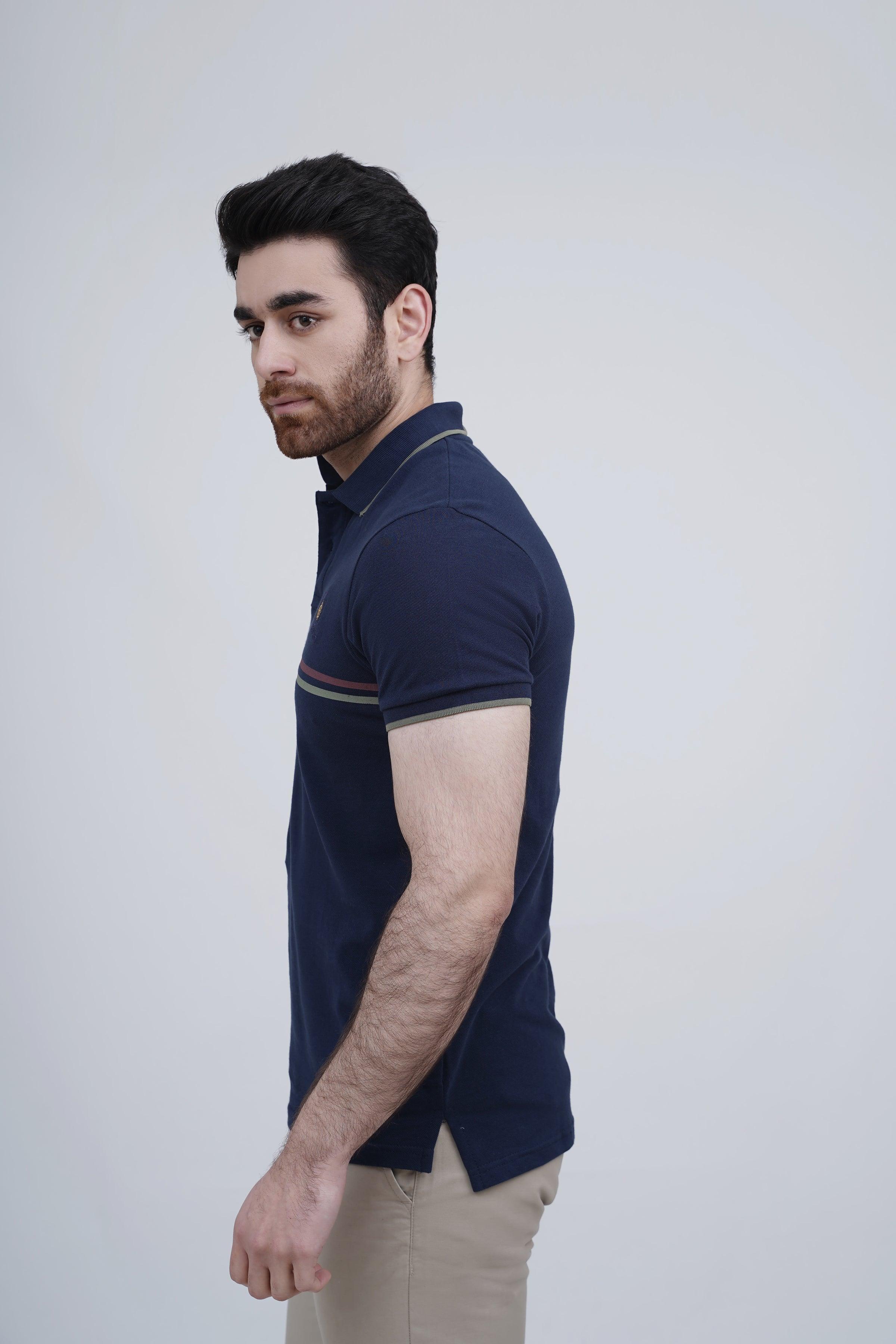 Navy polo shirt with short sleeves and striped cuff trim, side view