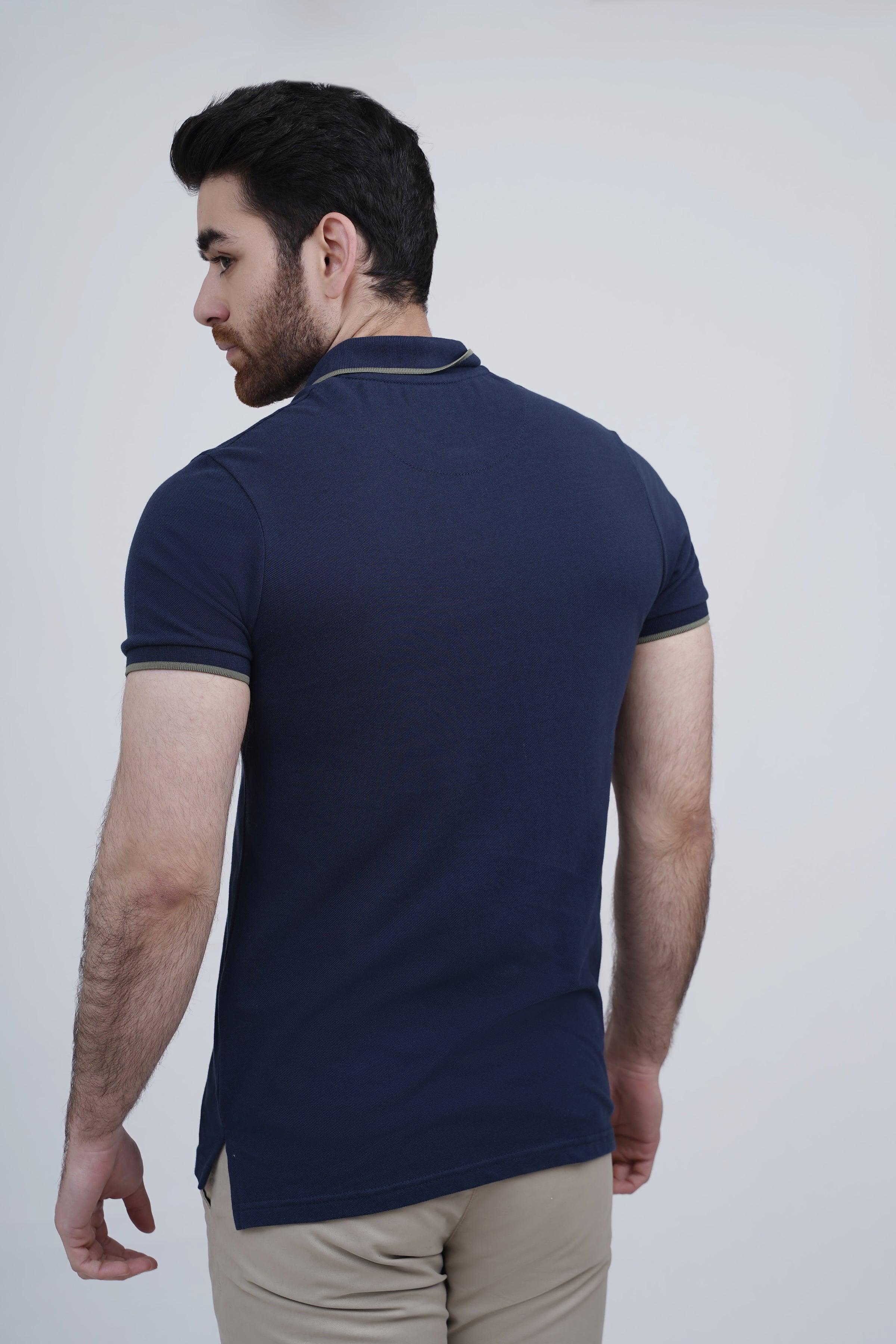 Navy polo shirt with ribbed collar and striped sleeve hem, back view