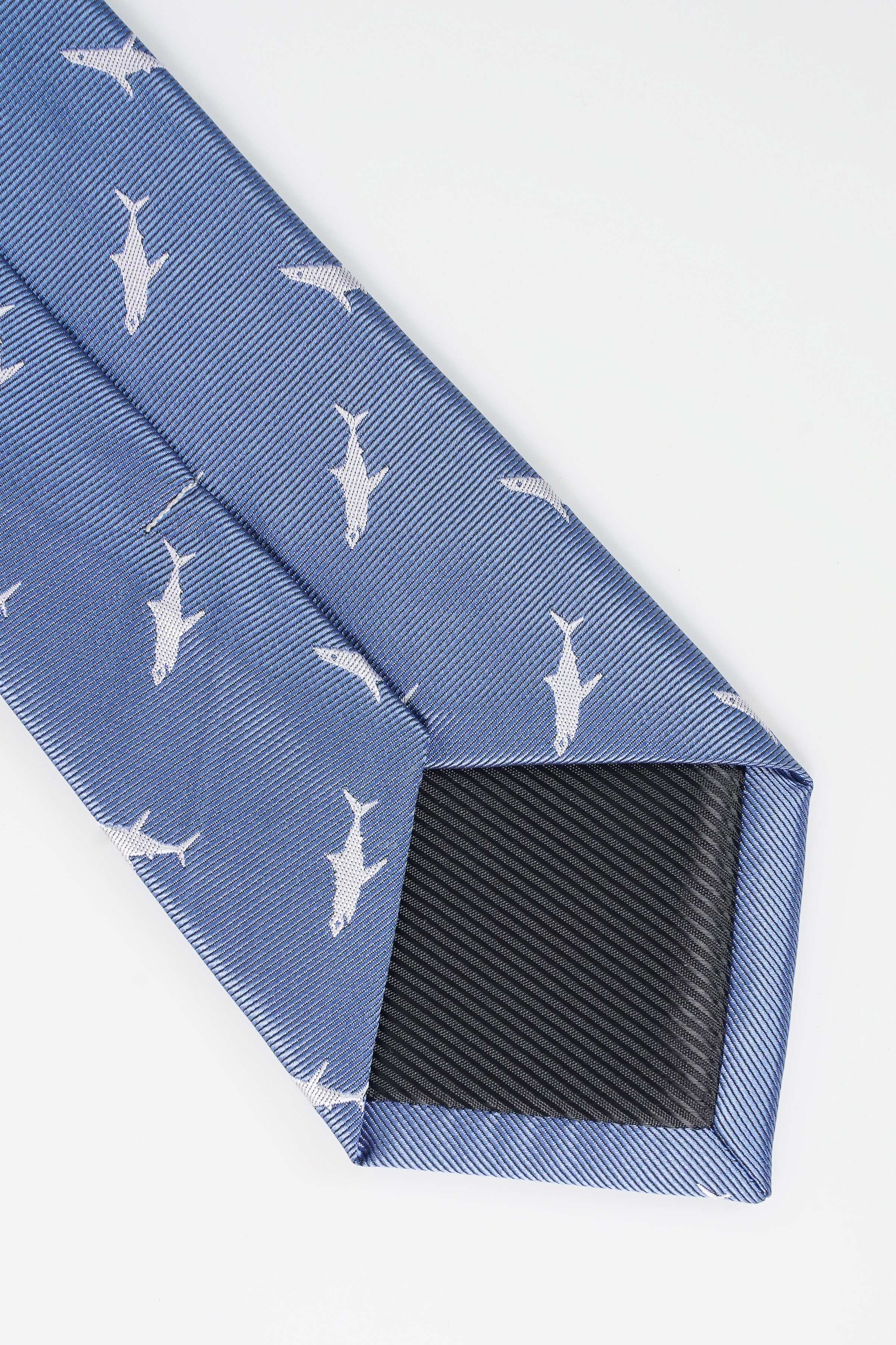 Blue necktie tip with white bird pattern and dark underside