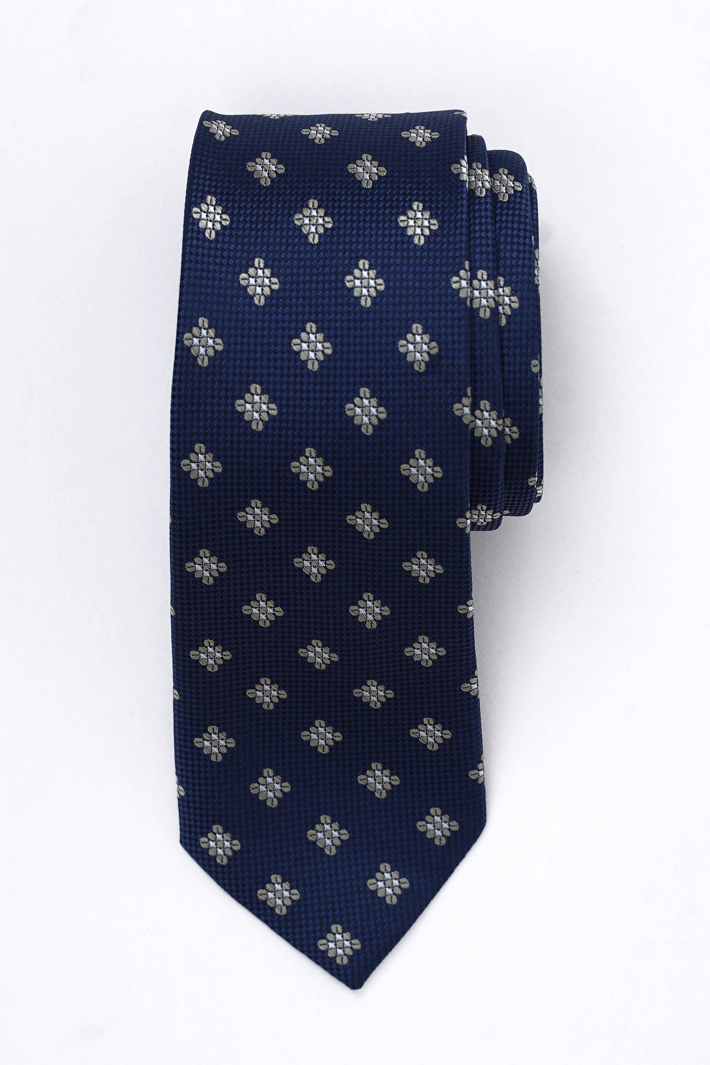 Navy blue poly silk tie with small repeating floral pattern in light gray