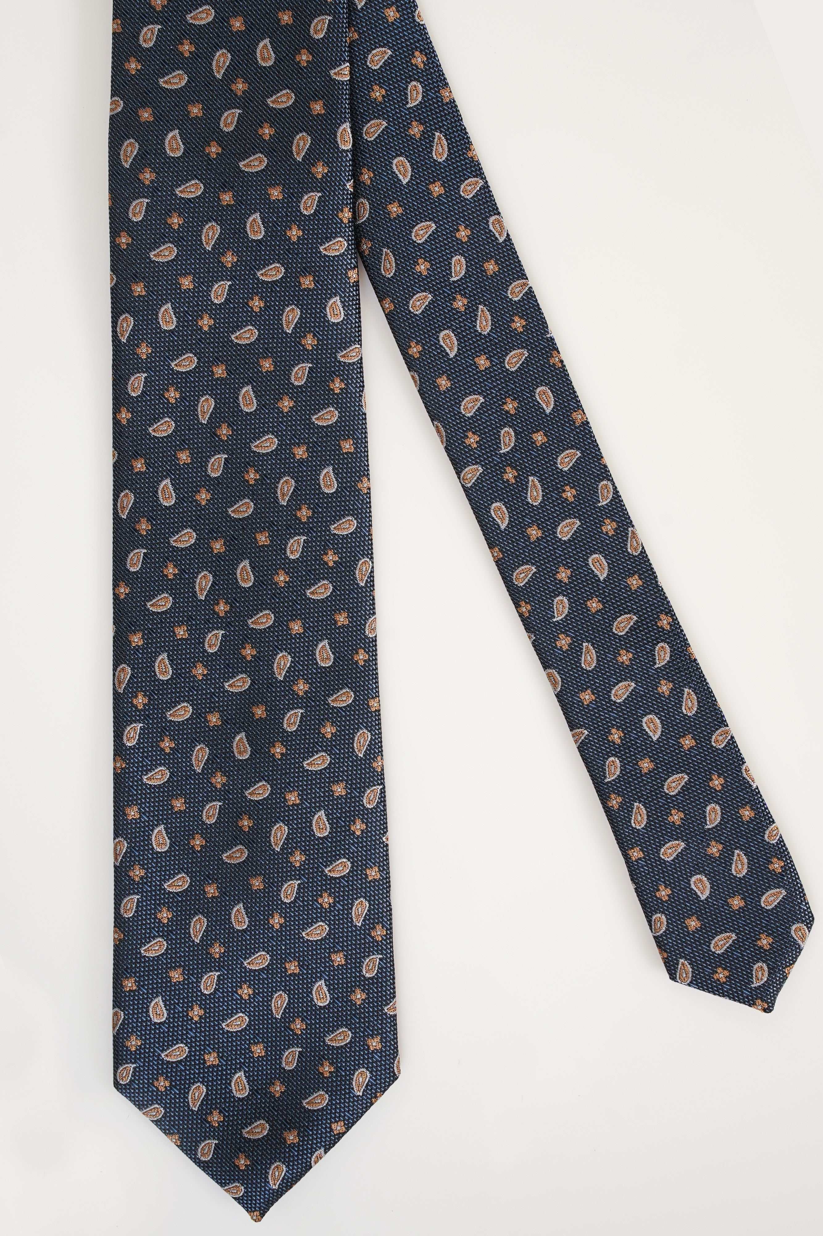 Poly silk tie in dark blue with small tan leaf and dotted pattern