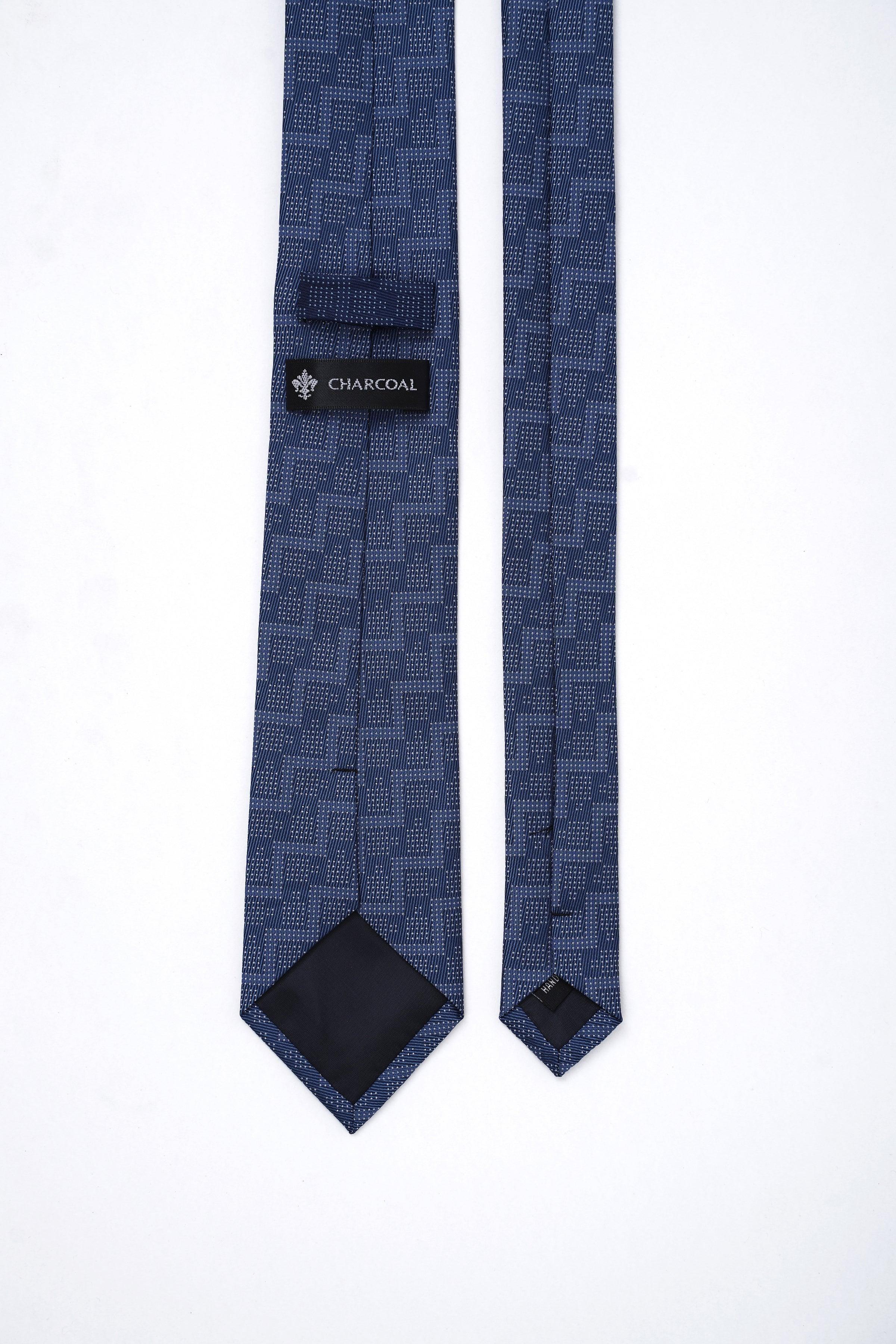 Navy blue poly silk tie with CHARCOAL label at knot, pointed ends