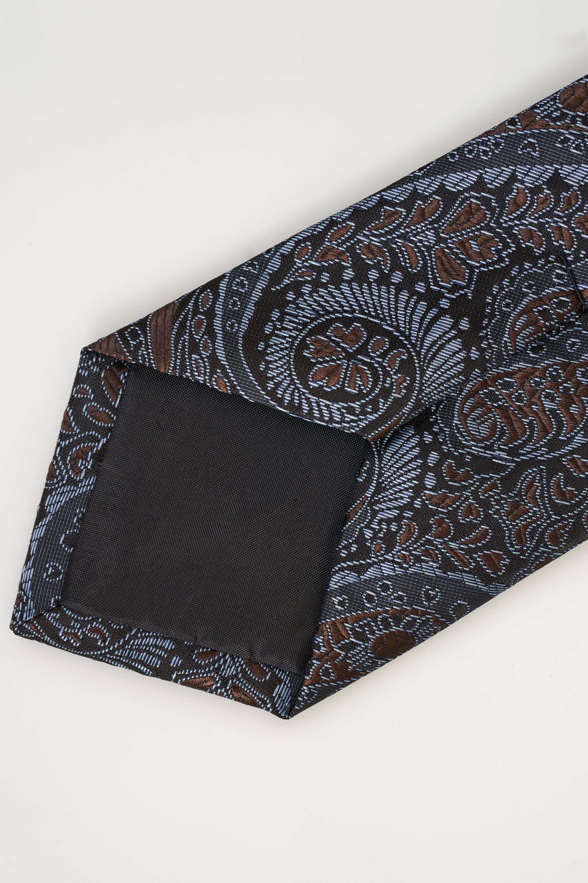 Dark blue paisley polyester tie with rust and teal motifs, folded corner.