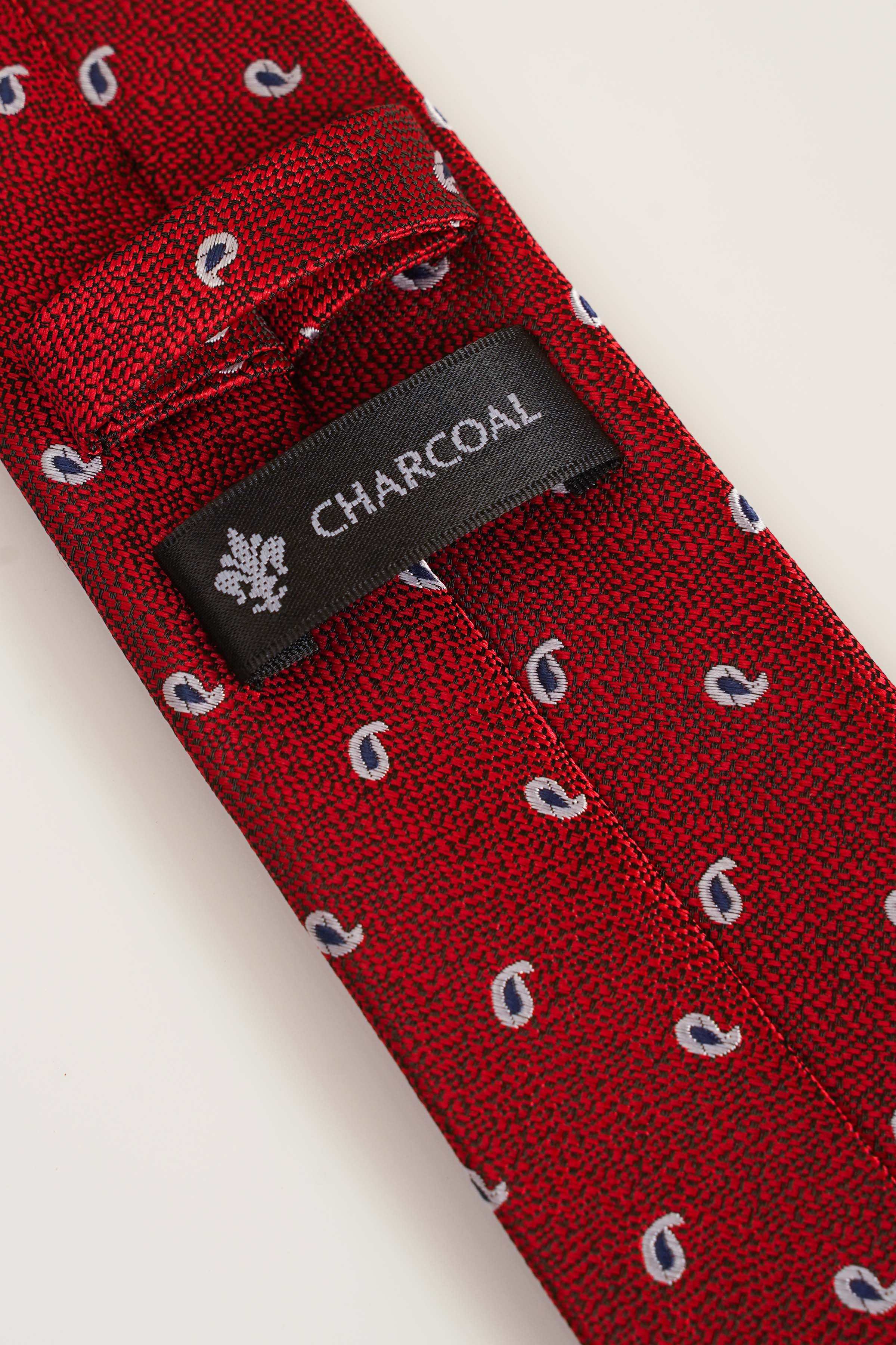 Red tie close-up with blue motifs and inner brand label