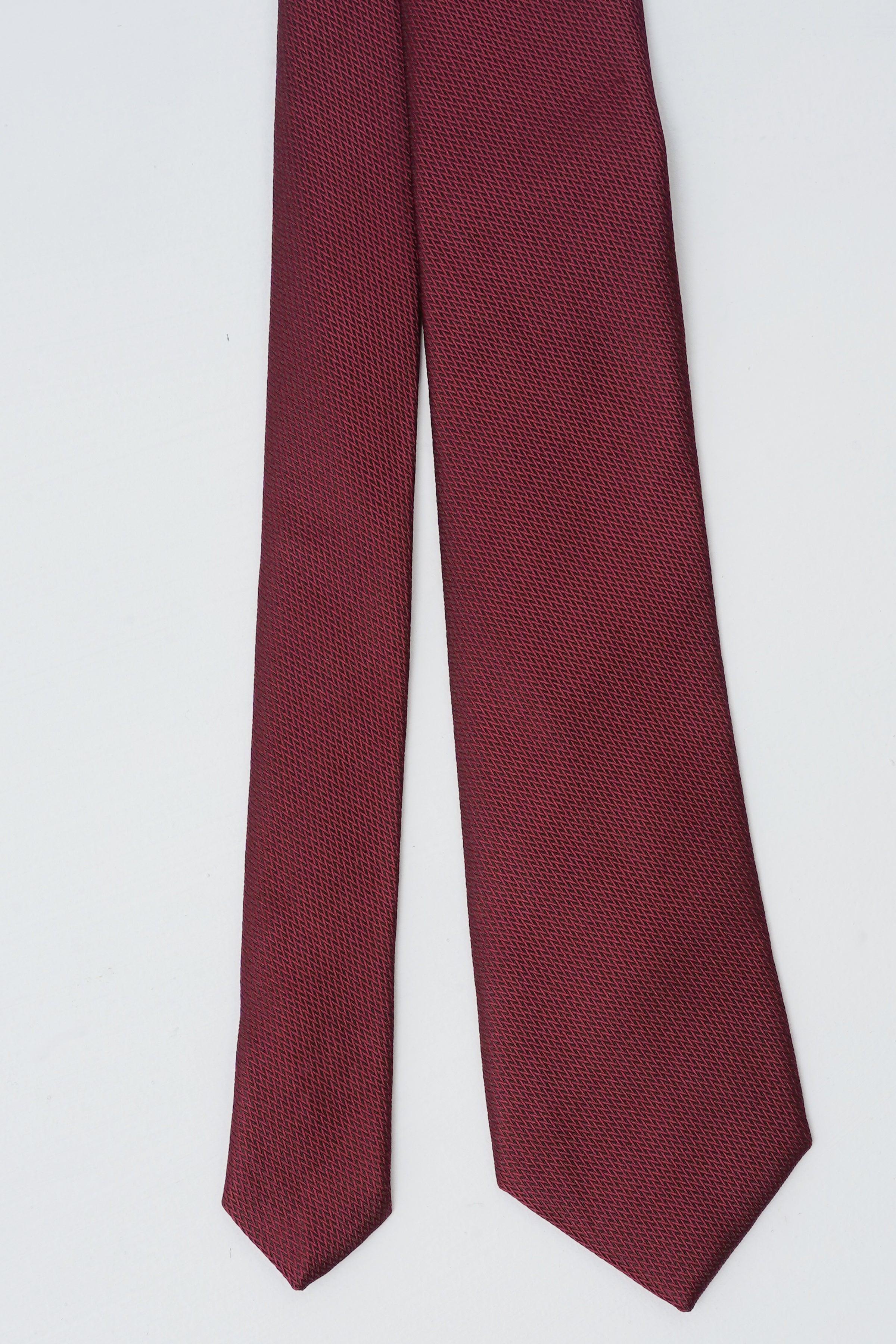 Burgundy poly-silk tie, straight view of long narrow width and pointed end